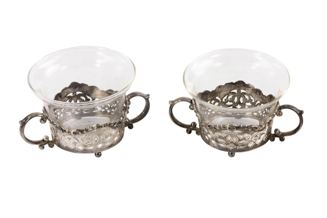 A sterling set of ten footed reticulated baked ramekin frames