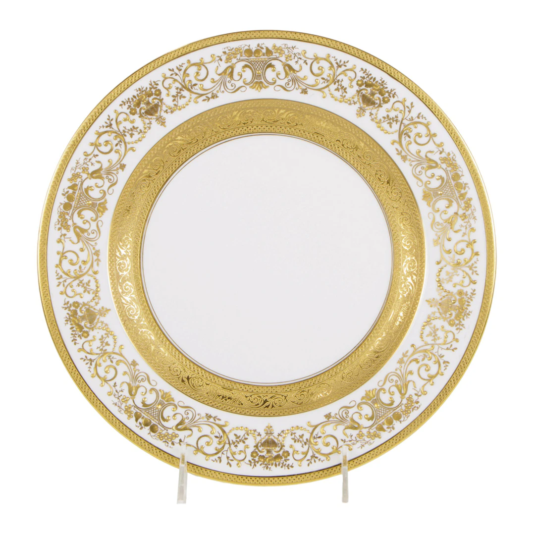 A set of twelve Hutschenreuther porcelain raised gilt decorated service plates