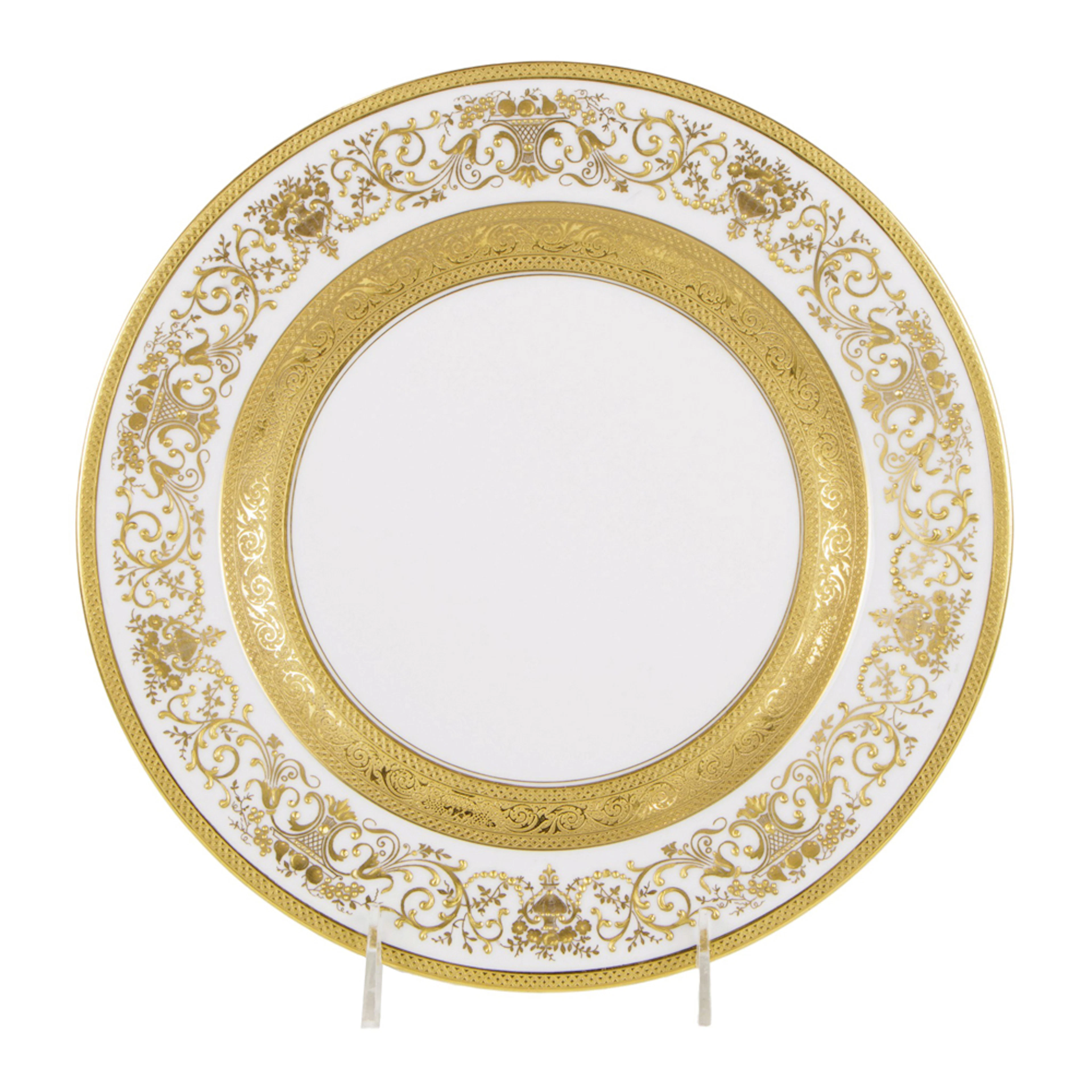 A set of twelve Hutschenreuther porcelain raised gilt decorated service plates
