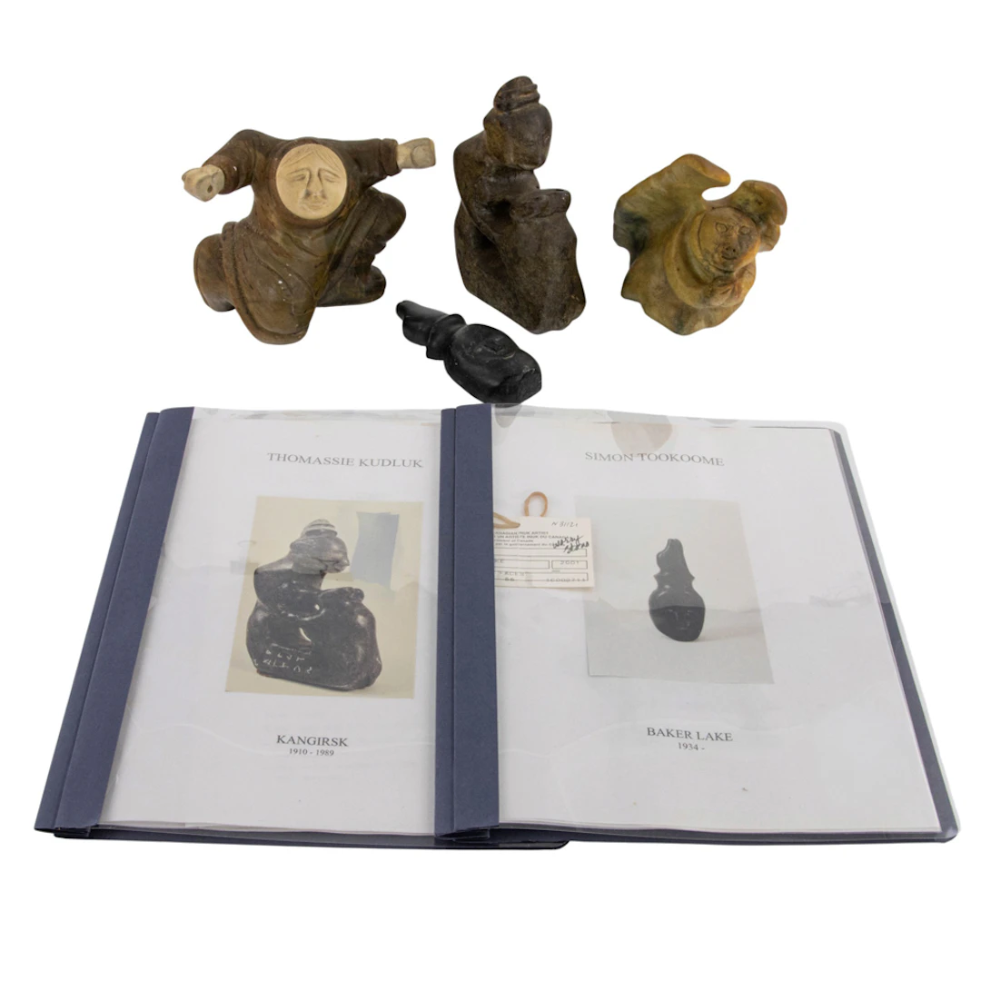 Four Inuit carved stone figures