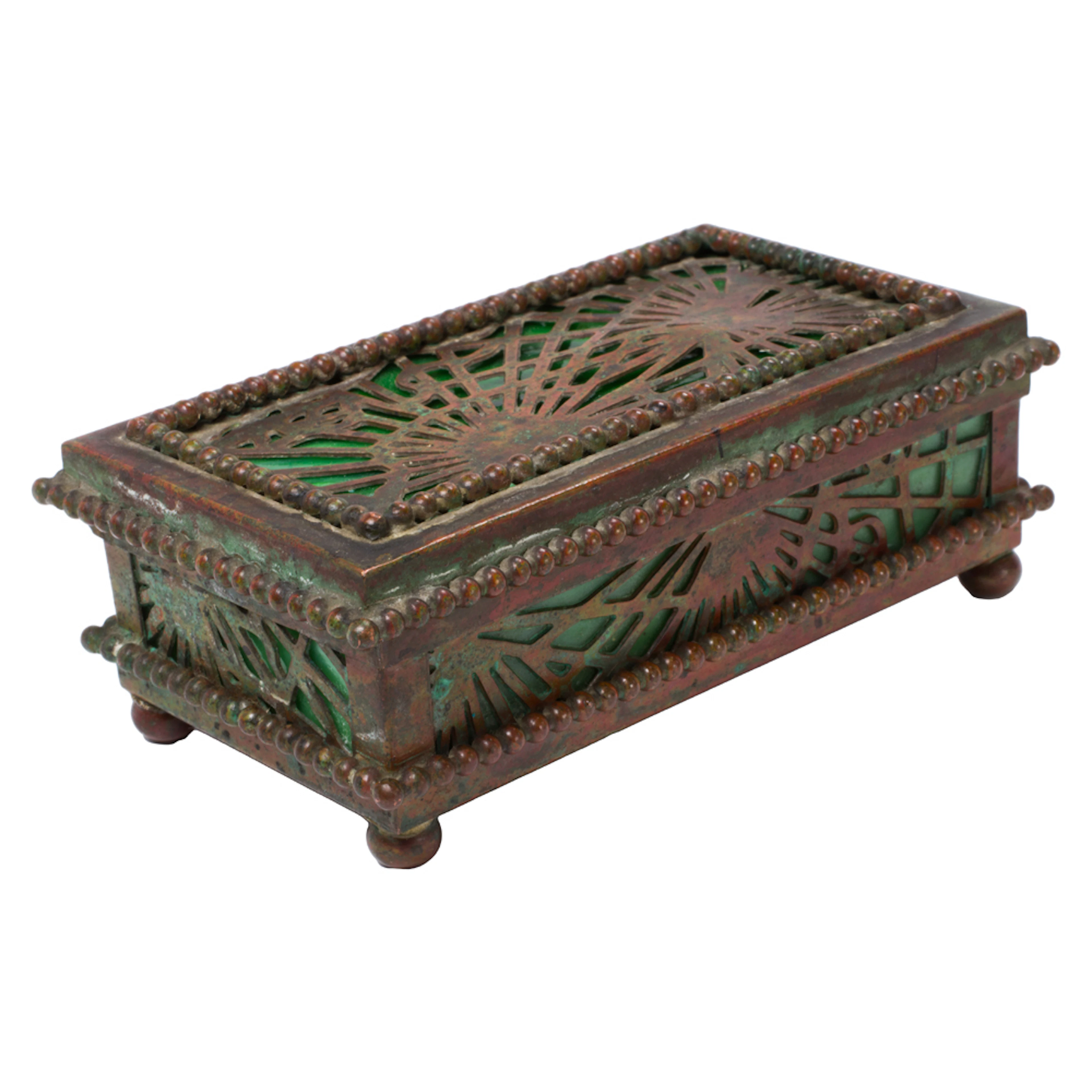 A Tiffany Studios patinated bronze and slag glass stamp box in the