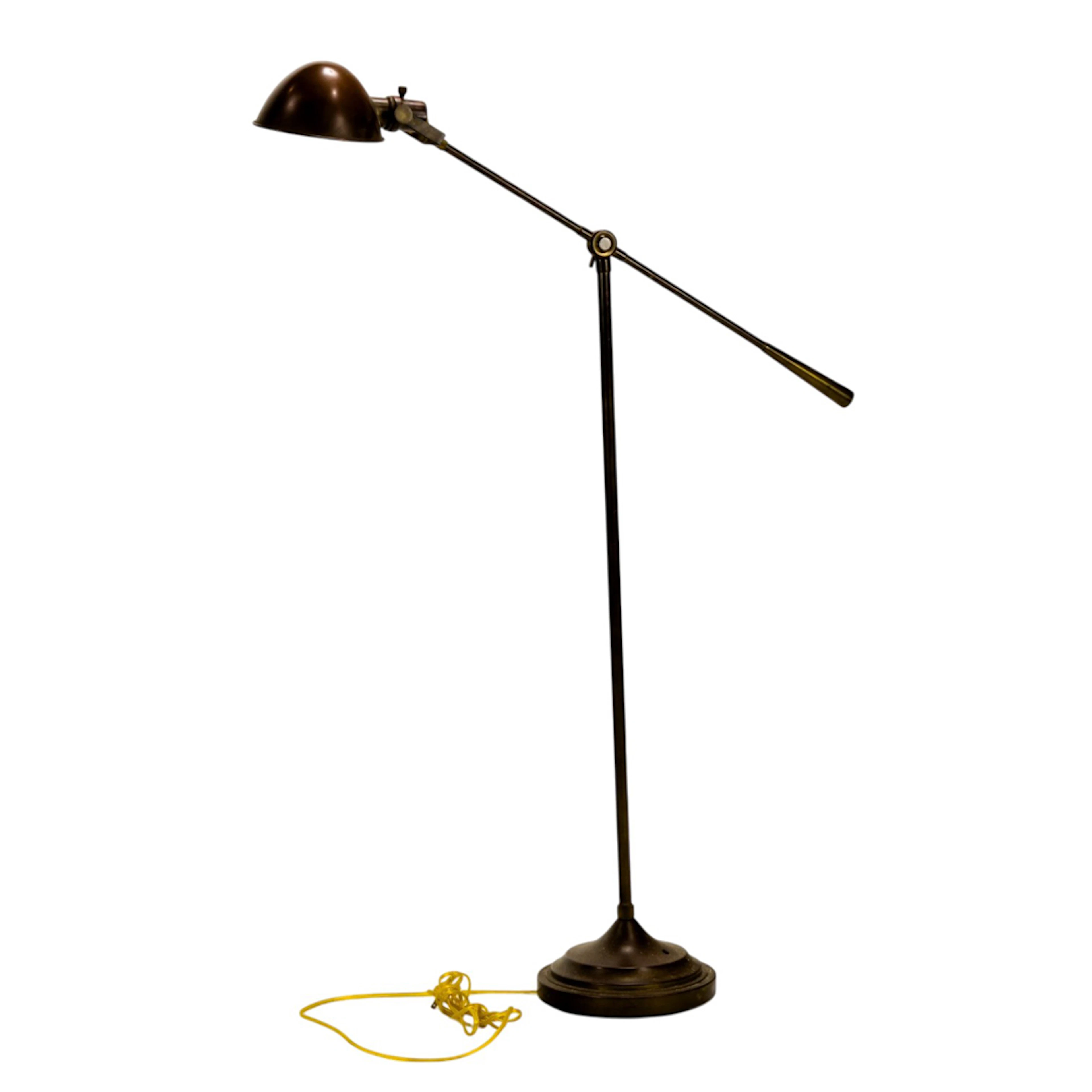 A bronze finish adjustable floor reading lamp