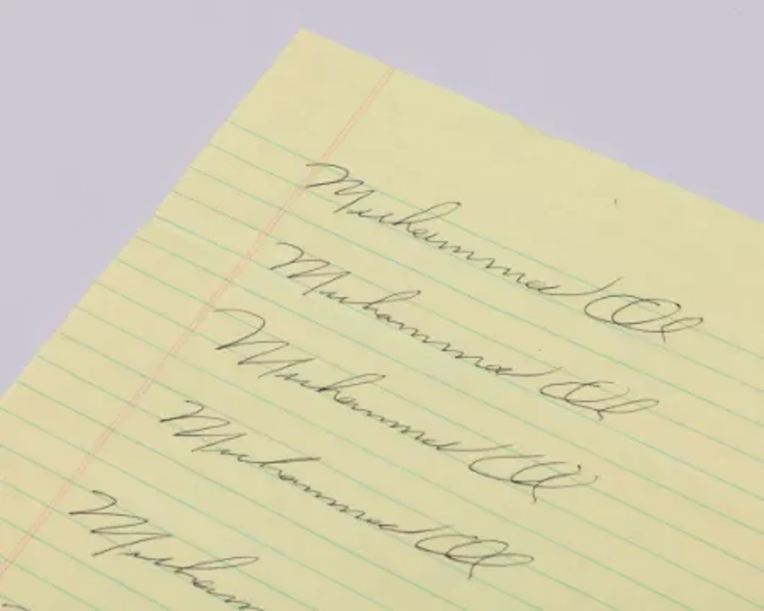 Seven Muhammad Ali autographs on a single sheet of A4 paper