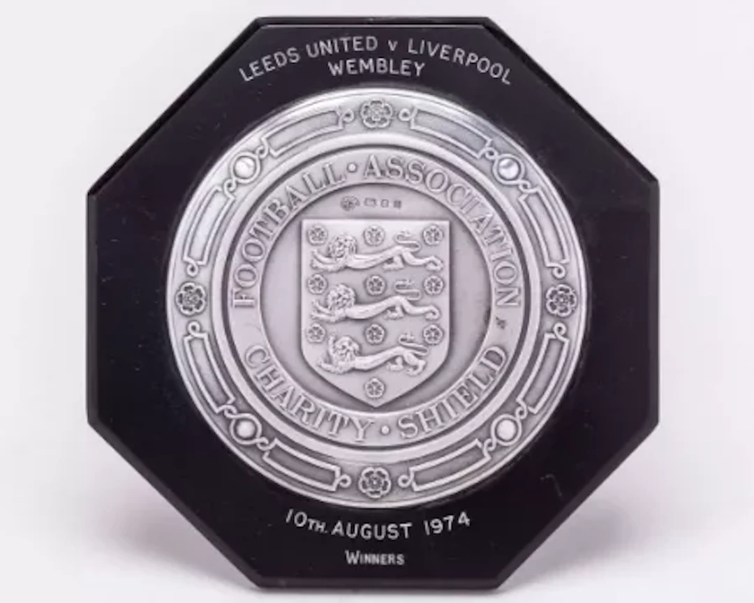 Emlyn Hughes a black bakelite and silver-mounted Charity Shield plaque, 1974