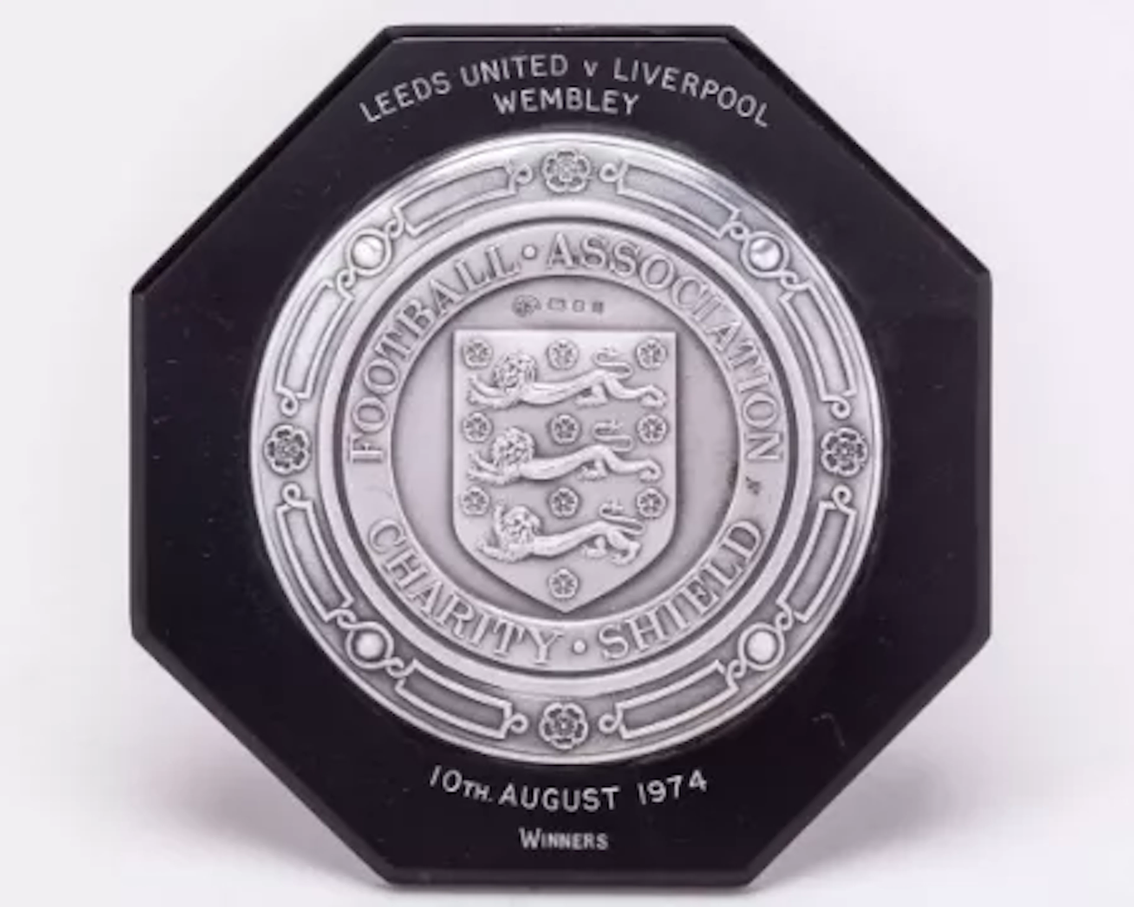 Emlyn Hughes a black bakelite and silver-mounted Charity Shield plaque, 1974