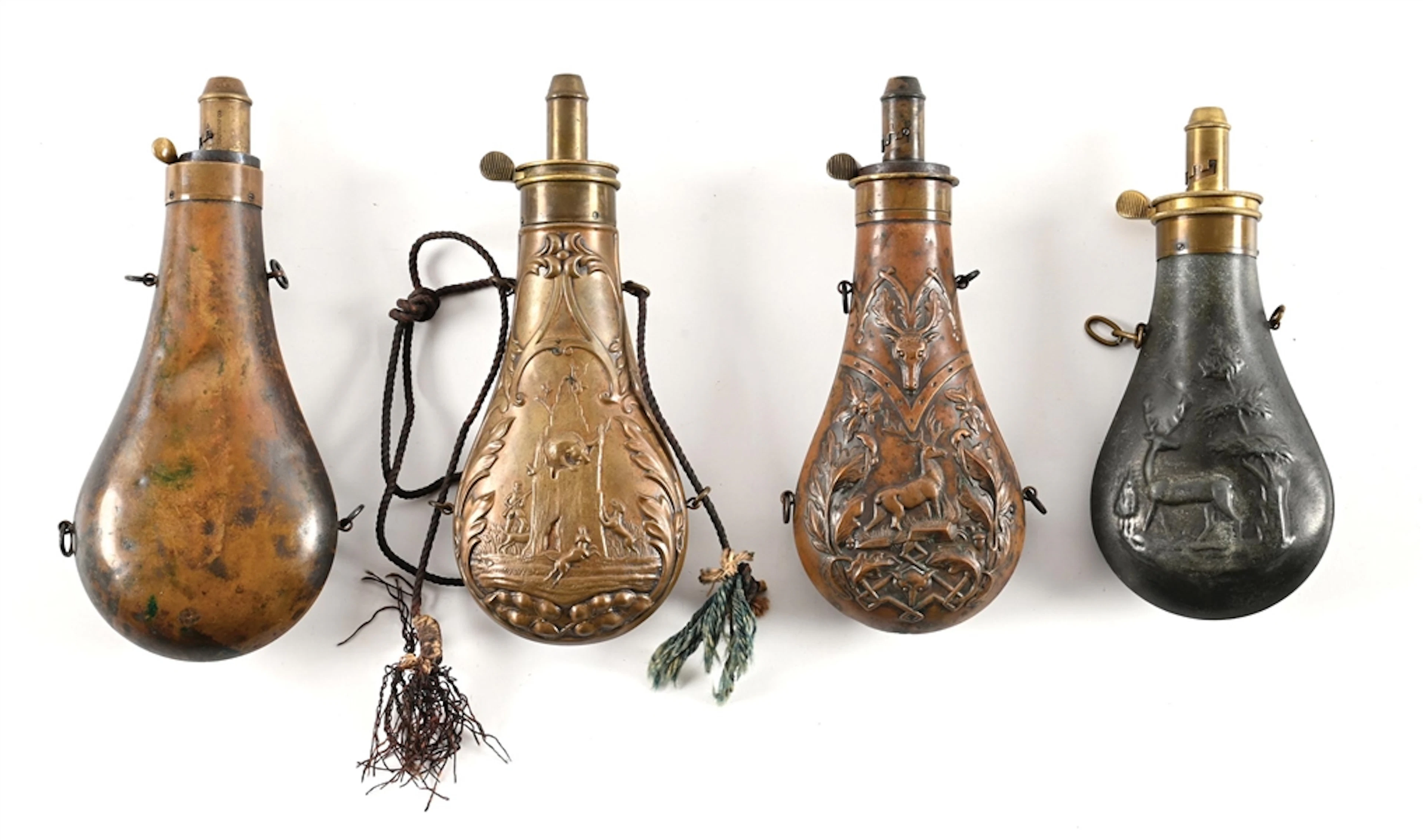 LOT OF 4: AMERICAN FLASK CO. HUNTING THEMED BRASS POWDER FLASKS.