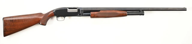 (C) DELUXE WINCHESTER MODEL 12 SLIDE ACTION SHOTGUN.