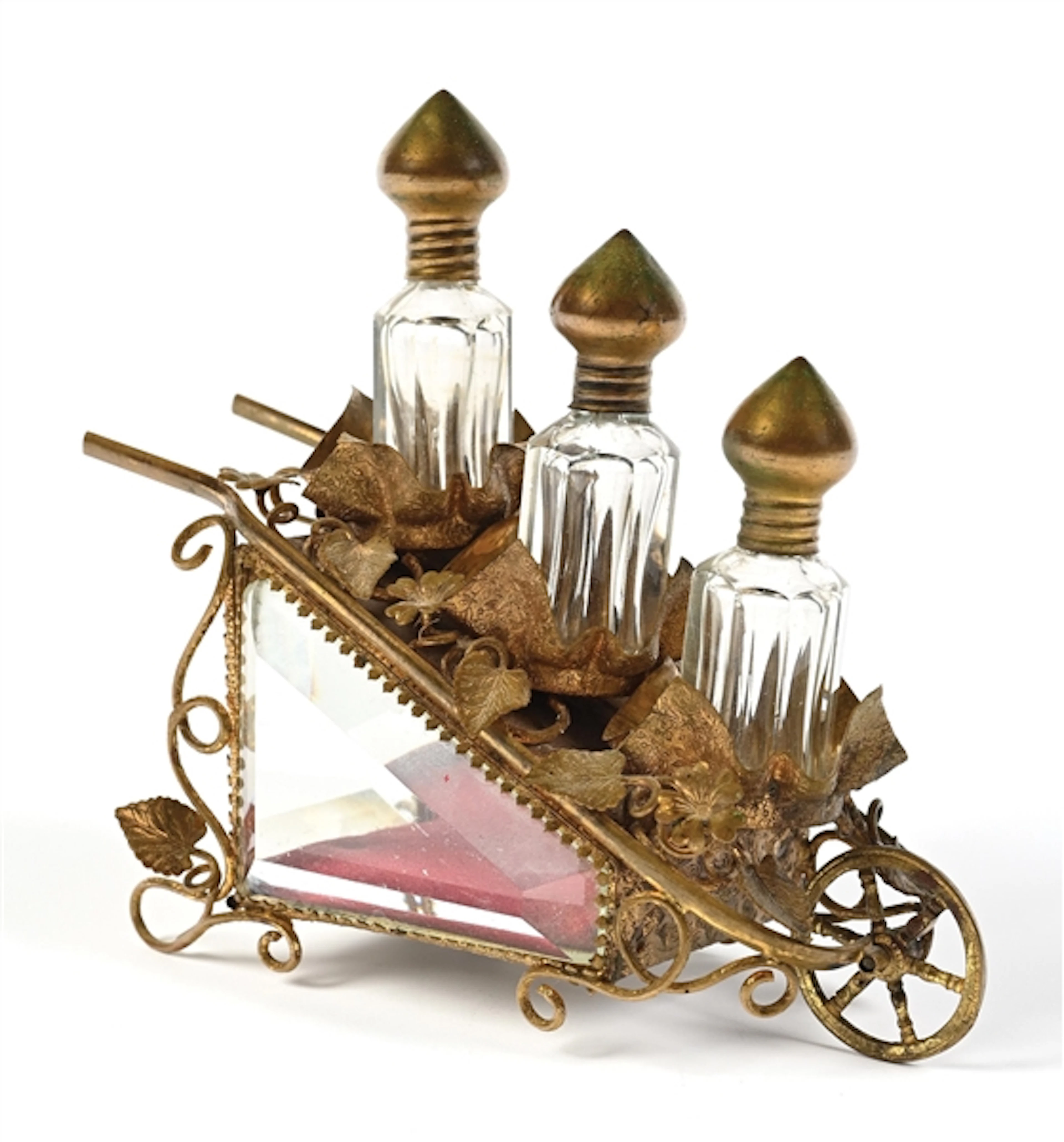 3 PERFUMES IN AN ORNATE GILDED METAL HOLDER WITH WHEEL