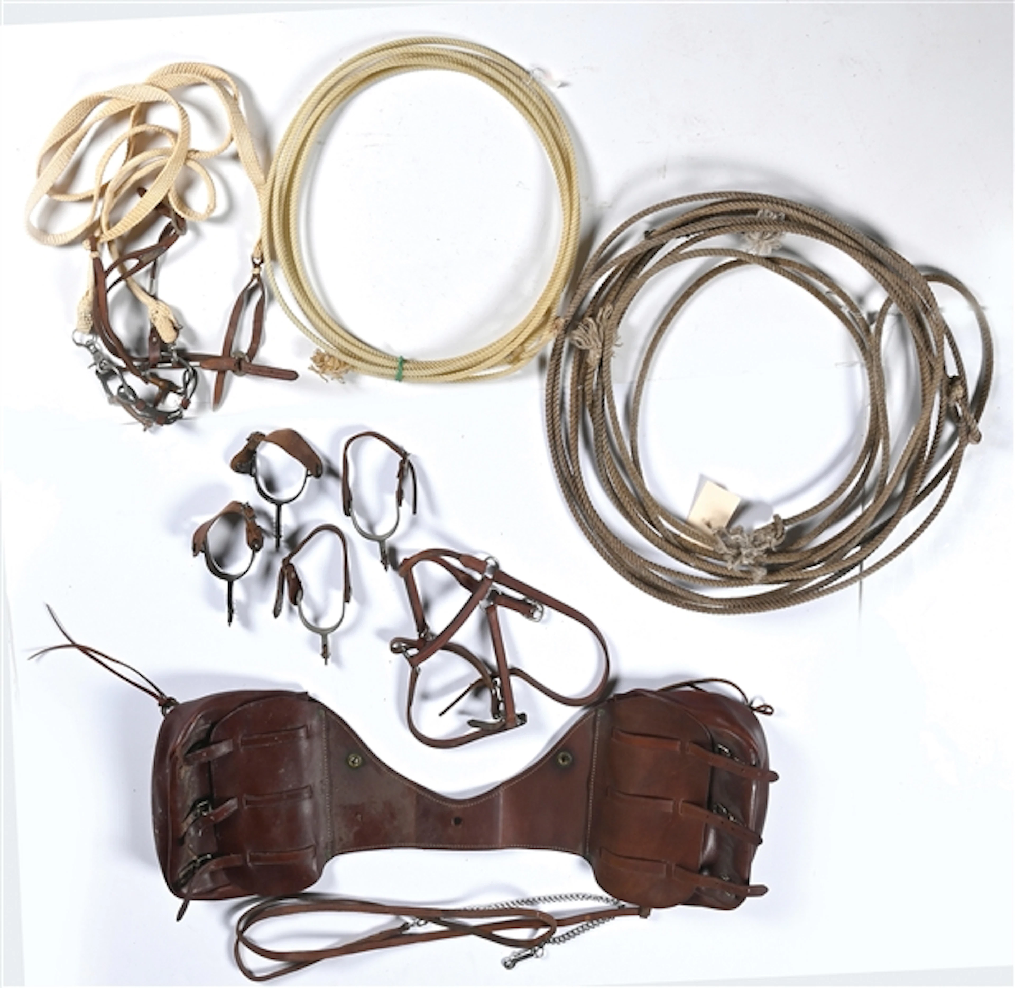 LOT OF 7: VARIOUS ROPES, SPURS, BRIDLES AND SADDLE BAGS