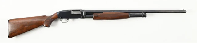 (C) WINCHESTER MODEL 12 SLIDE ACTION SHOTGUN.