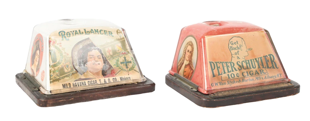 A PAIR OF COUNTERTOP CLOCKWORK GLASS ADVERTISING CIGAR CUTTERS