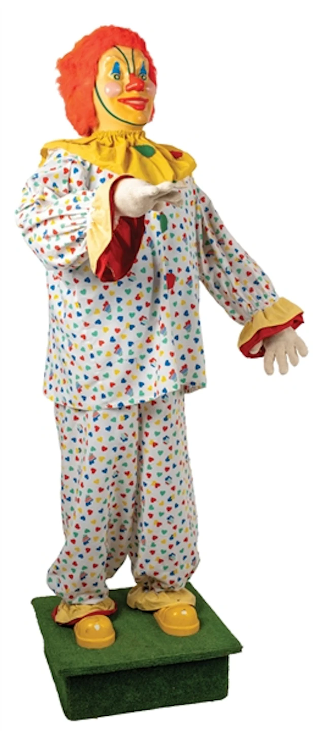 LARGE AUTOMATON CLOWN ON GREEN BASE WITH WHEELS