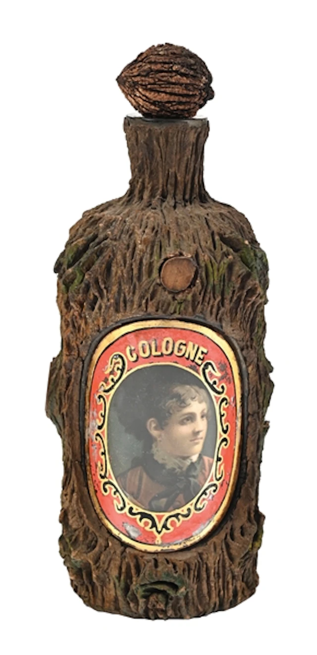 BARK-COVERED “COLOGNE” BARBER BOTTLE WITH PORTRAIT LABEL