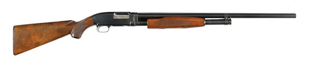 (C) DELUXE WINCHESTER MODEL 12 SLIDE ACTION SHOTGUN.