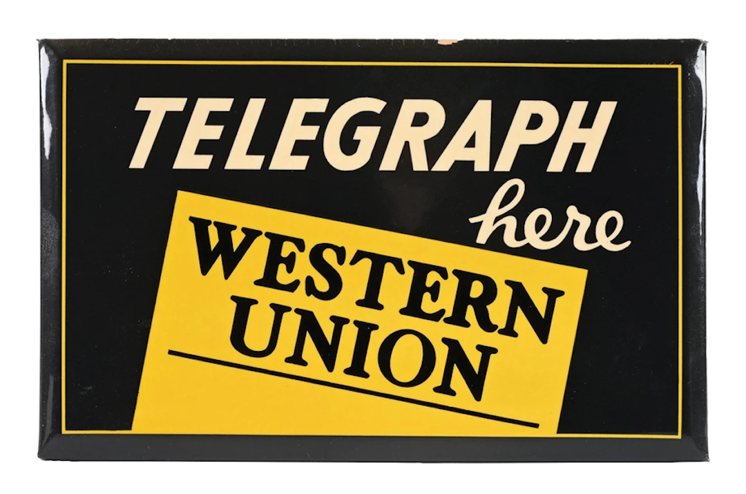 WESTERN UNION TELEGRAPH HERE CELLULOID OVER CARDBOARD SIGN W/ EASEL BACK.