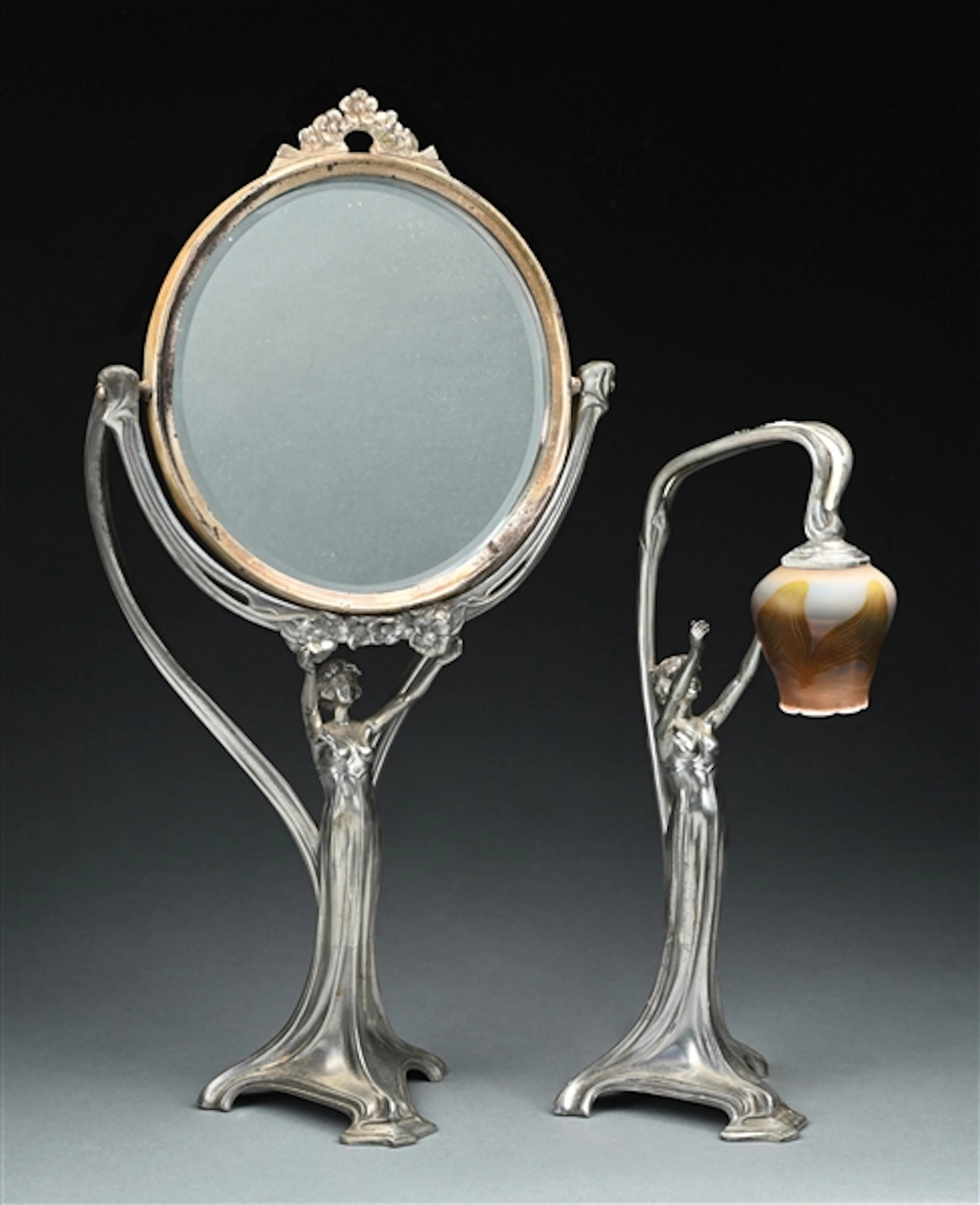 WMF ART NOUVEAU VANITY SUITE COMPROMISING A FIGURAL MIRROR AND BOUDOIR