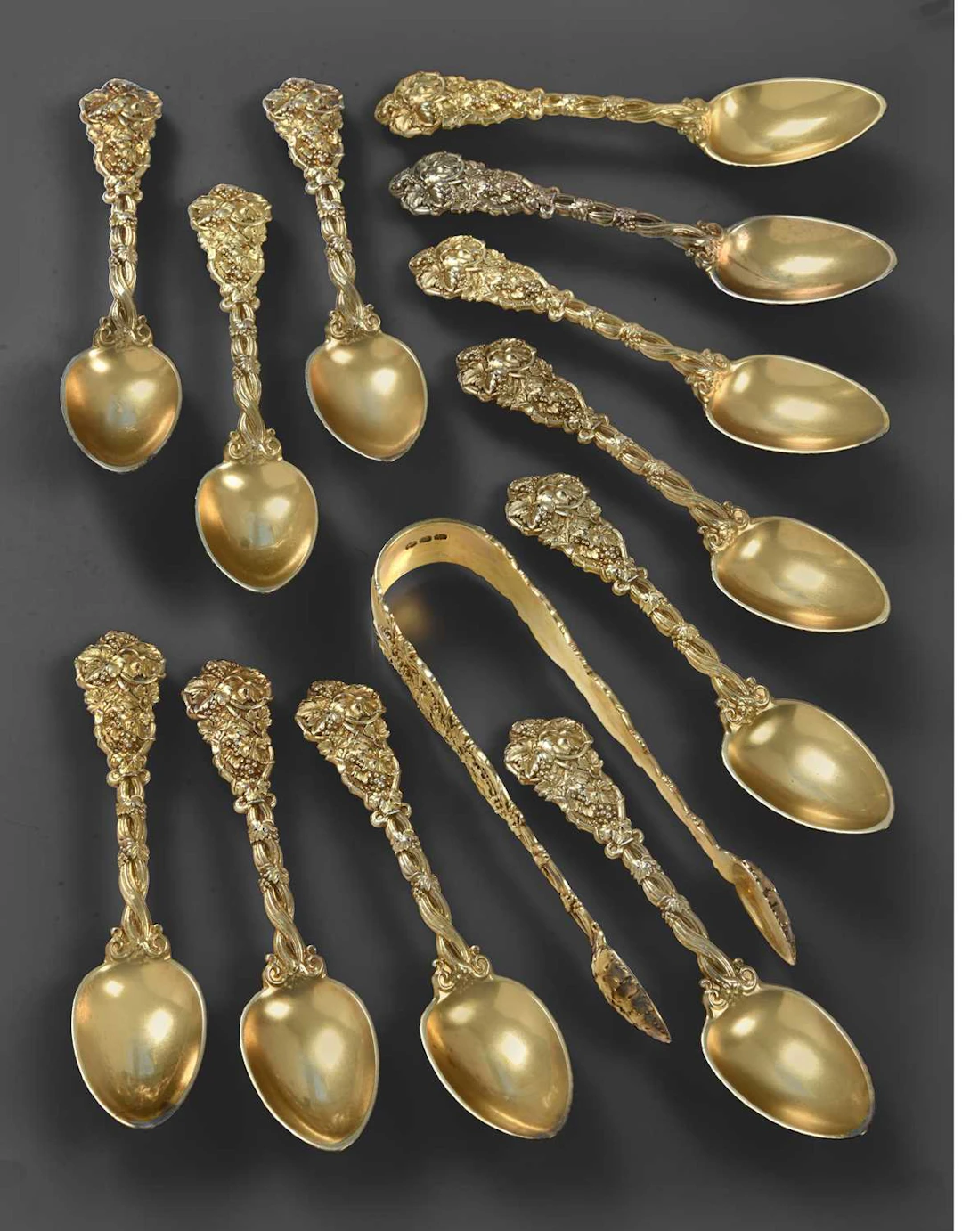 A Set of Twelve George III Silver-Gilt Teaspoons and a Pair of Sugar-Tongs