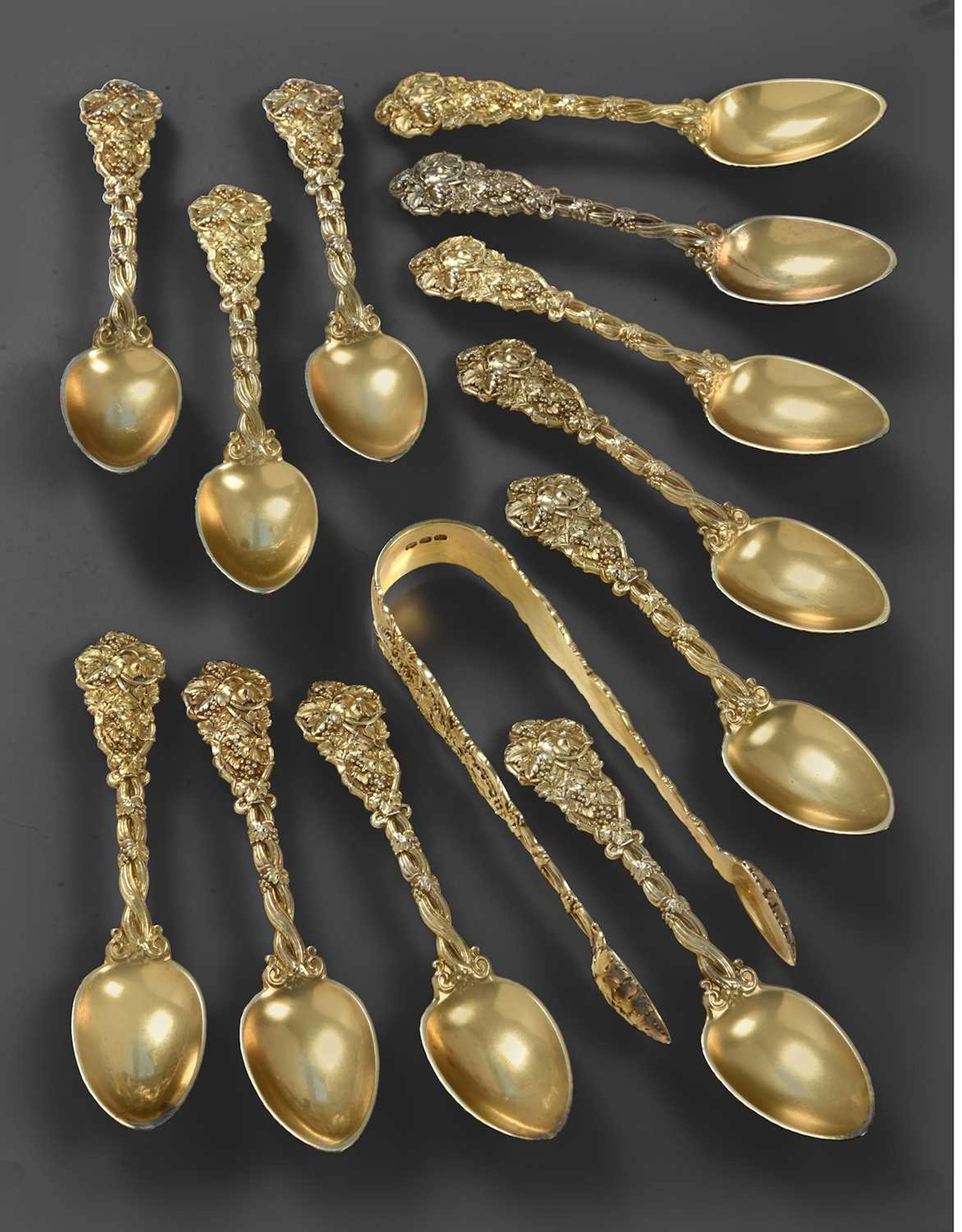 A Set of Twelve George III Silver-Gilt Teaspoons and a Pair of Sugar-Tongs