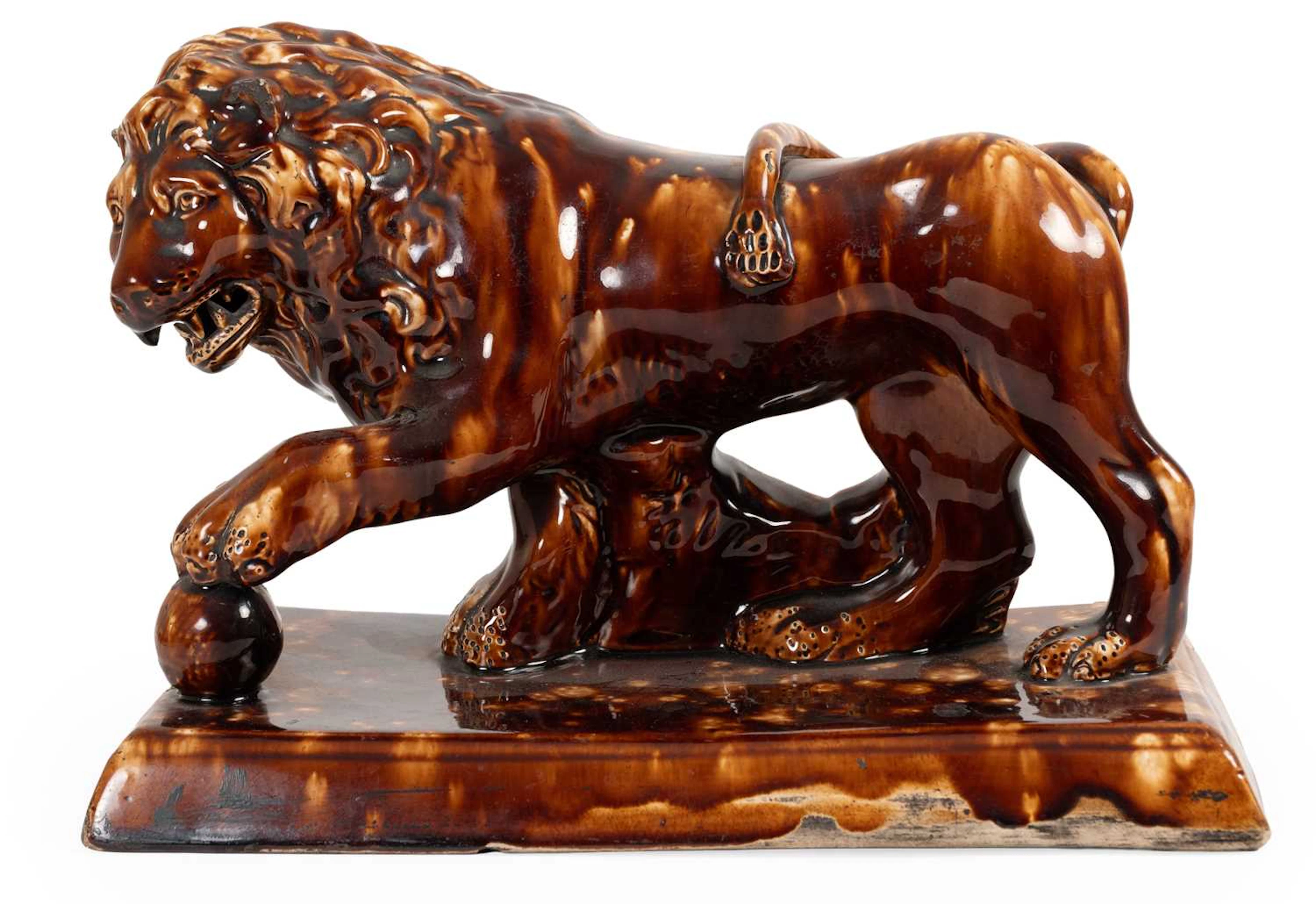 A Staffordshire Treacle Glazed Pottery Model of a Medici Lion, mid-19th