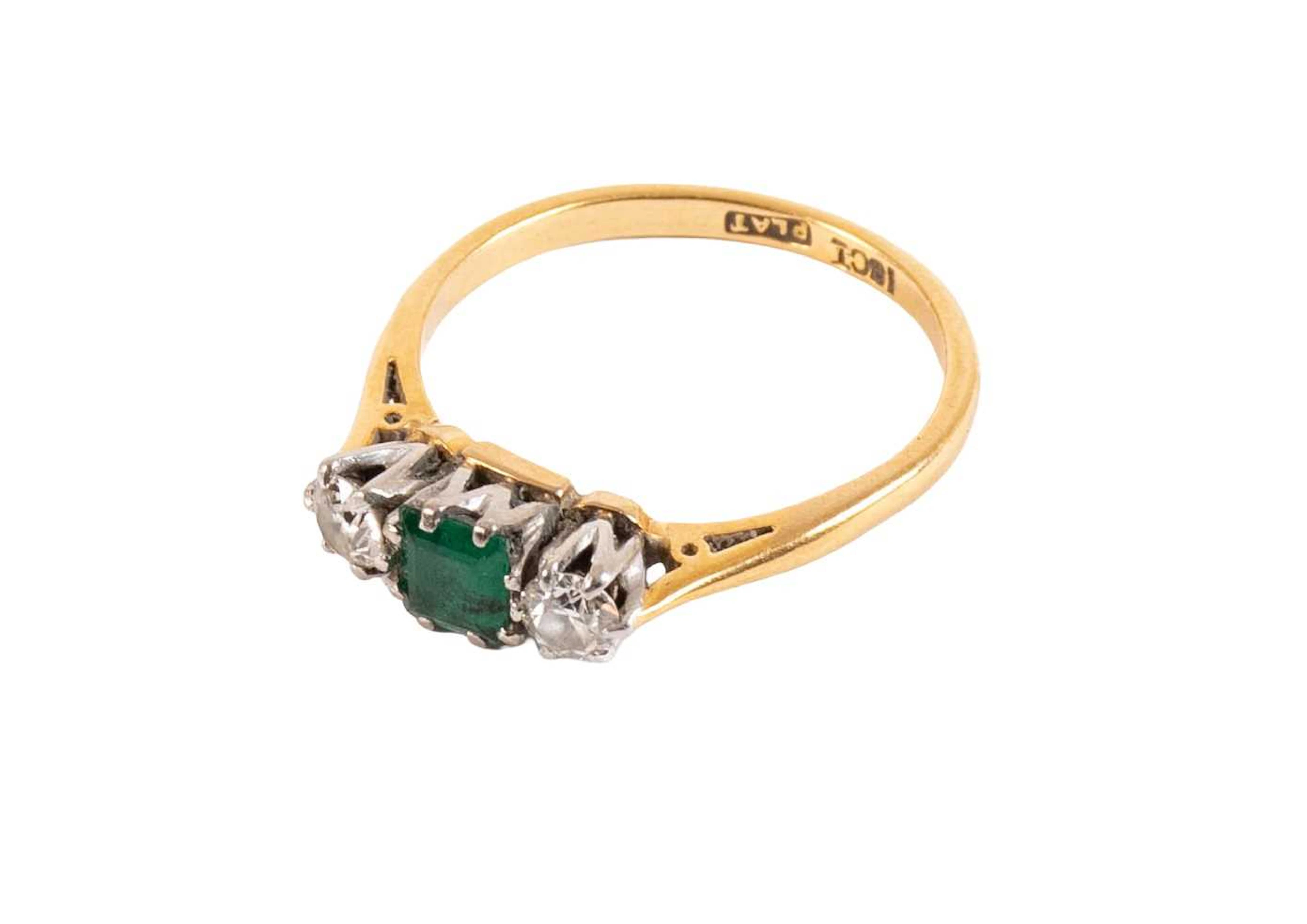 An Emerald and Diamond Three Stone Ring