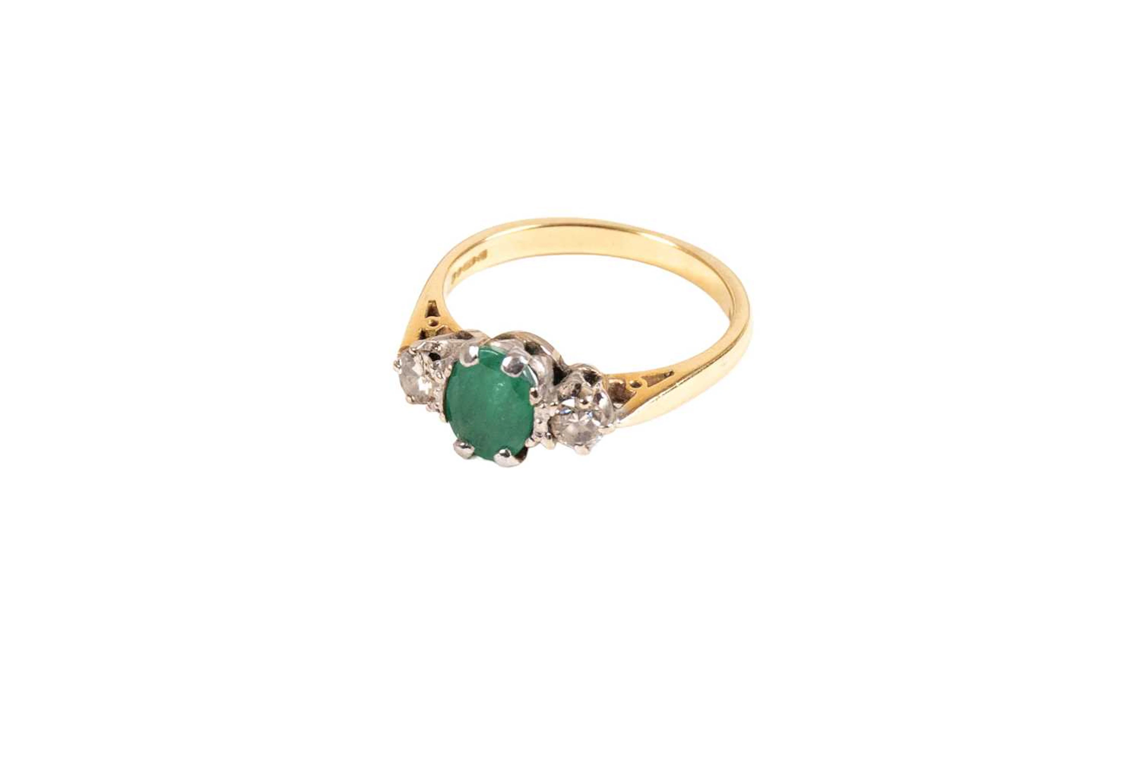 An 18 Carat Gold Emerald and Diamond Three Stone Ring