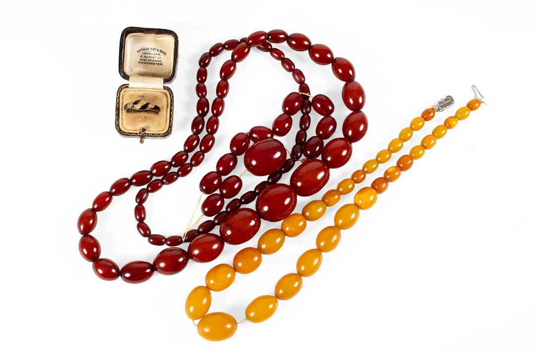 An 18 Carat Gold Split Pearl and Enamel Ring, An Amber and Amber Type