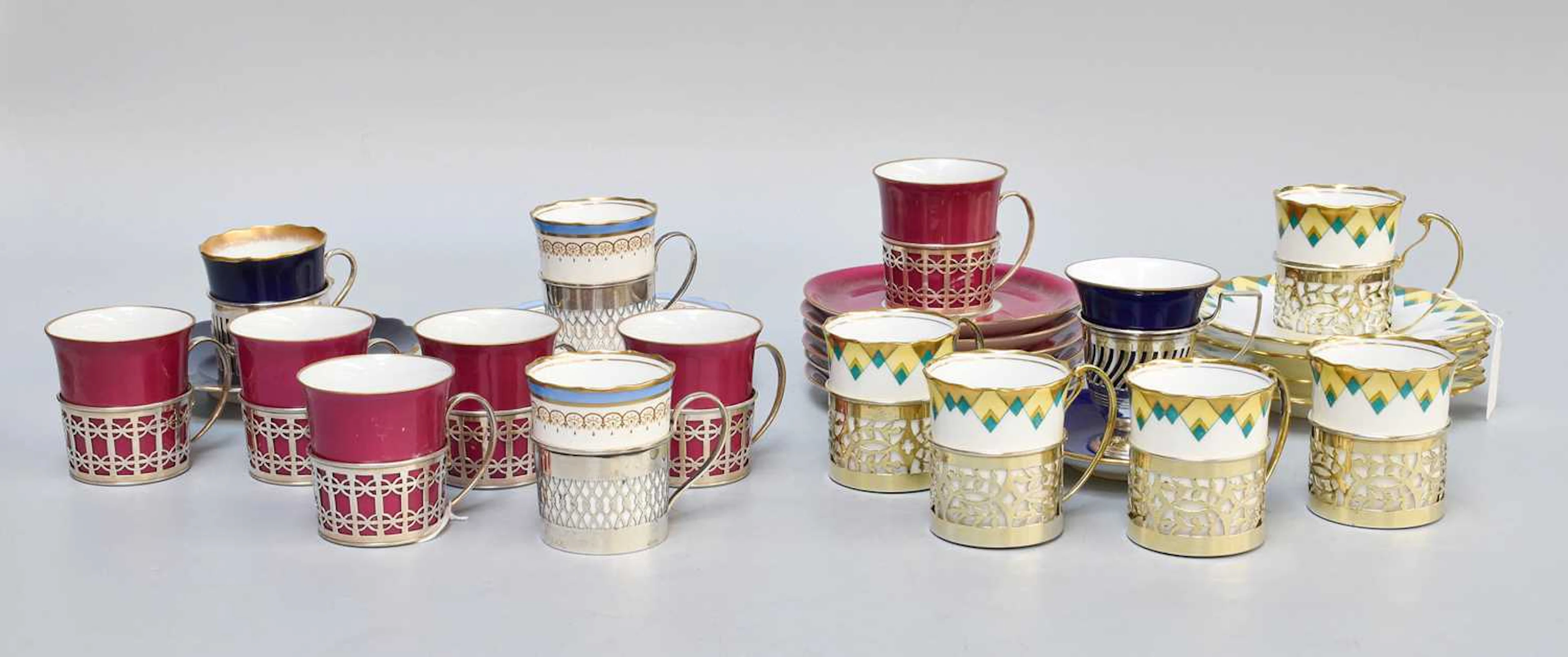 A Collection of Assorted Silver-Mounted Porcelain Cups and Saucers