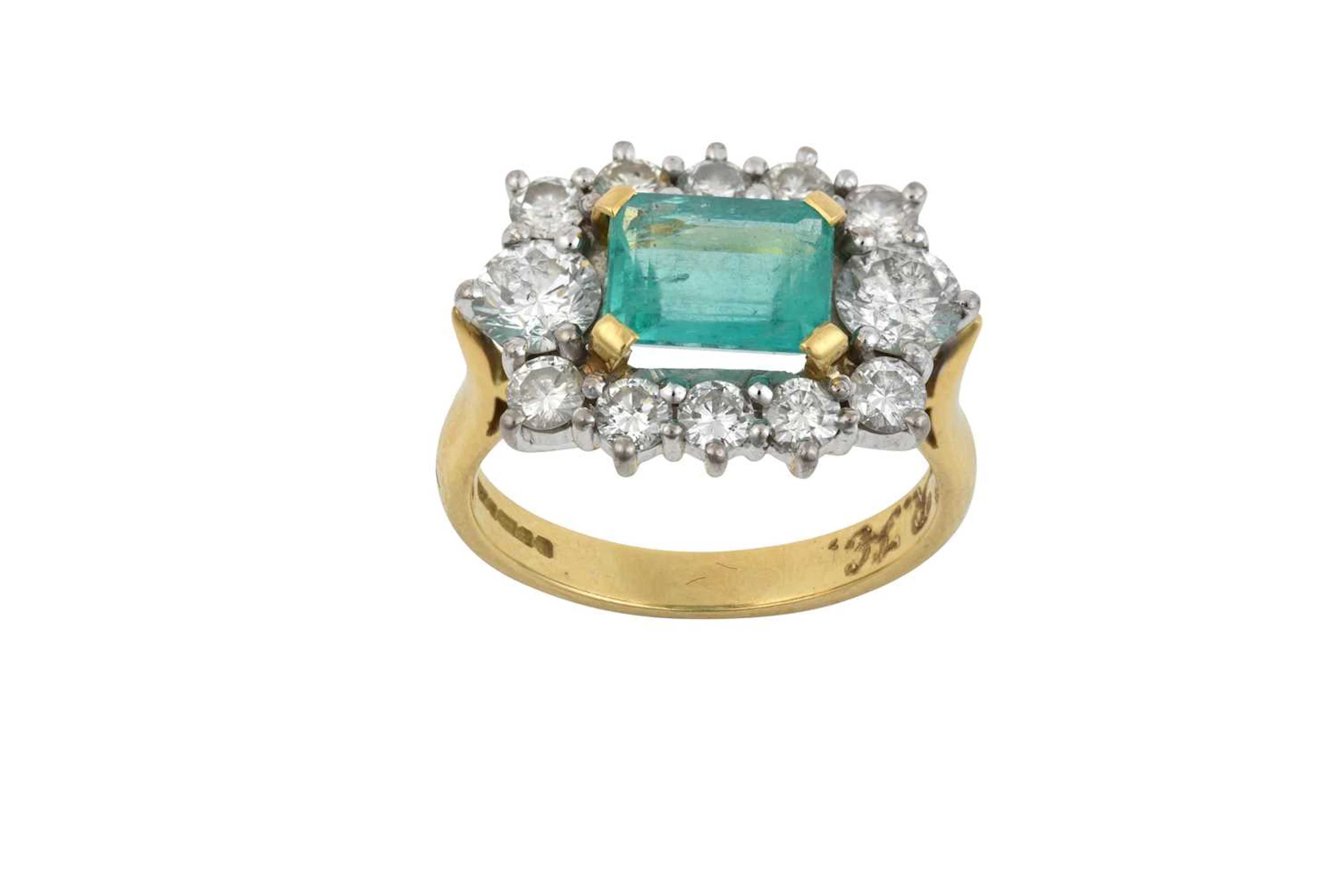 An 18 Carat Gold Emerald and Diamond Cluster Ring