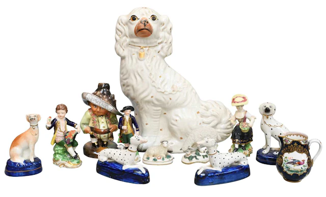 A Pair of Staffordshire Pottery Pen Rests Mounted with Recumbent Dalmatians