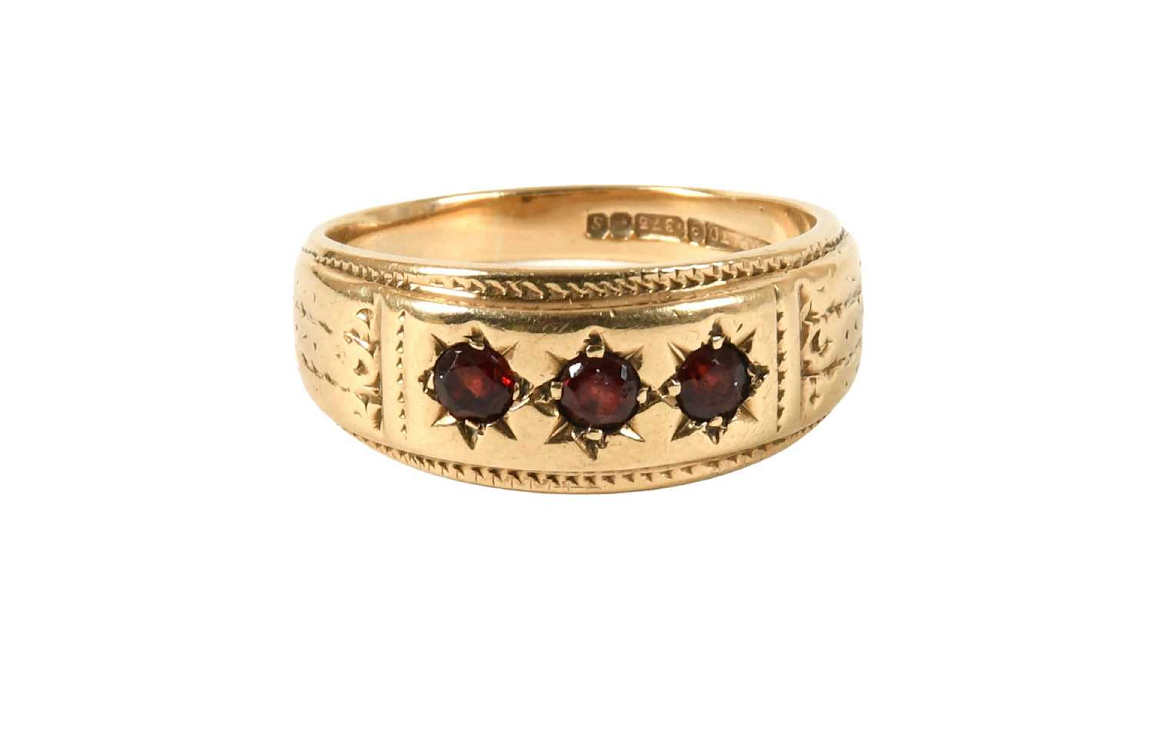 A 9 Carat Gold Garnet Three Stone Ring