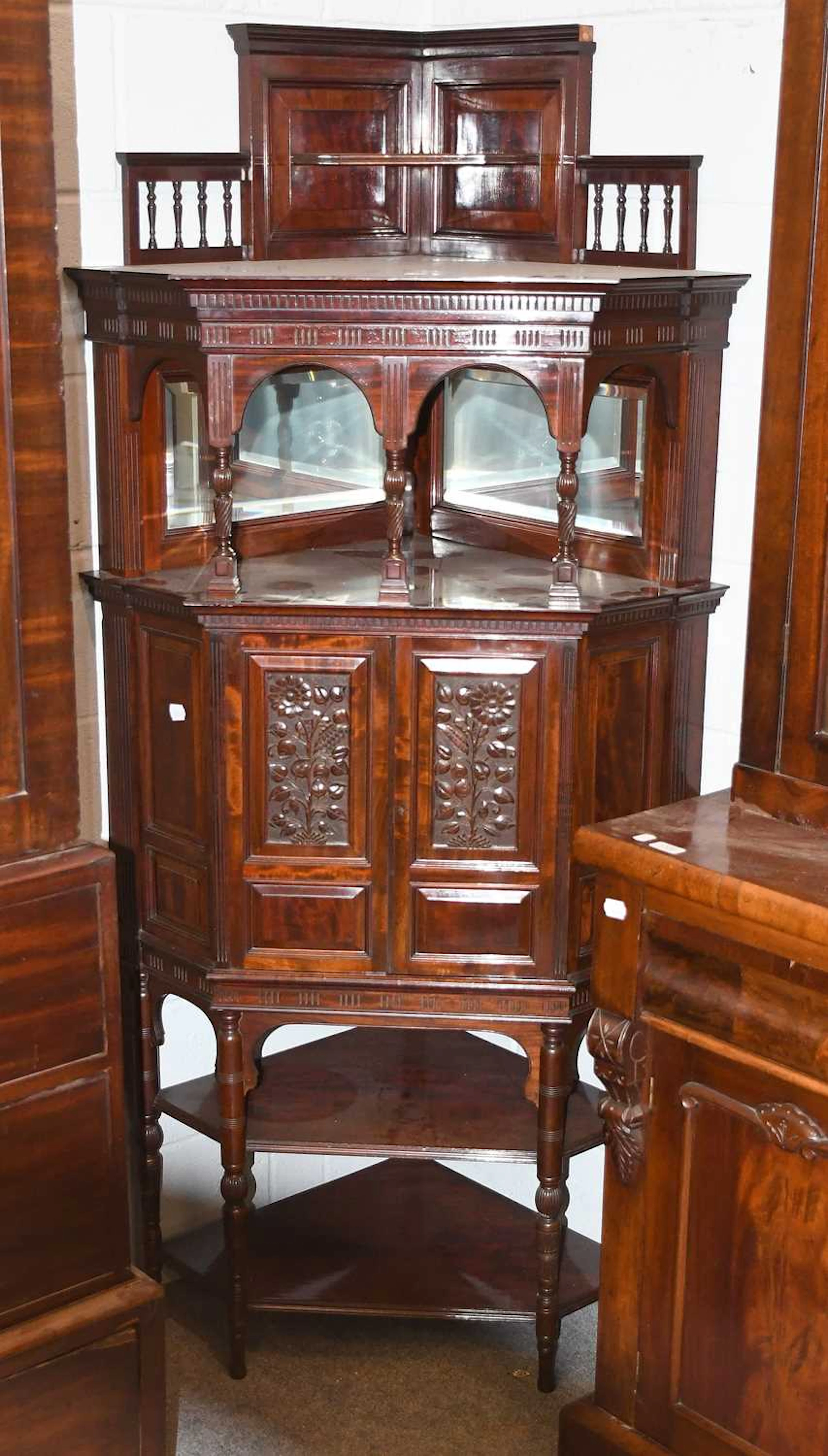 An Edwardian Mirrored and Carved Mahogany Freestanding Corner Cabinet
