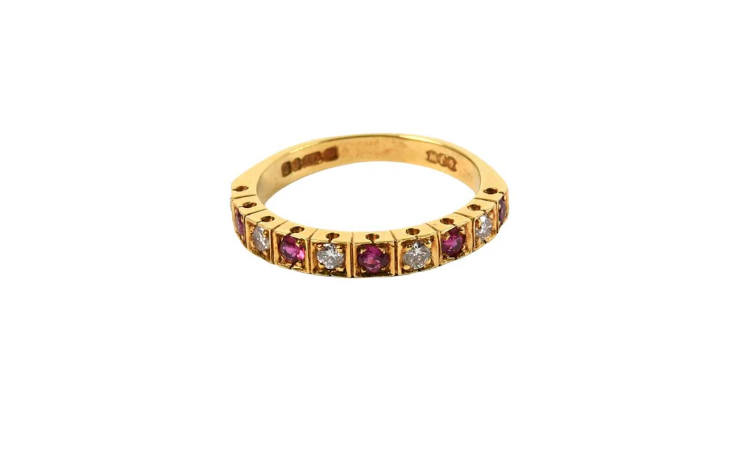 An 18 Carat Gold Ruby and Diamond Half Hoop Ring