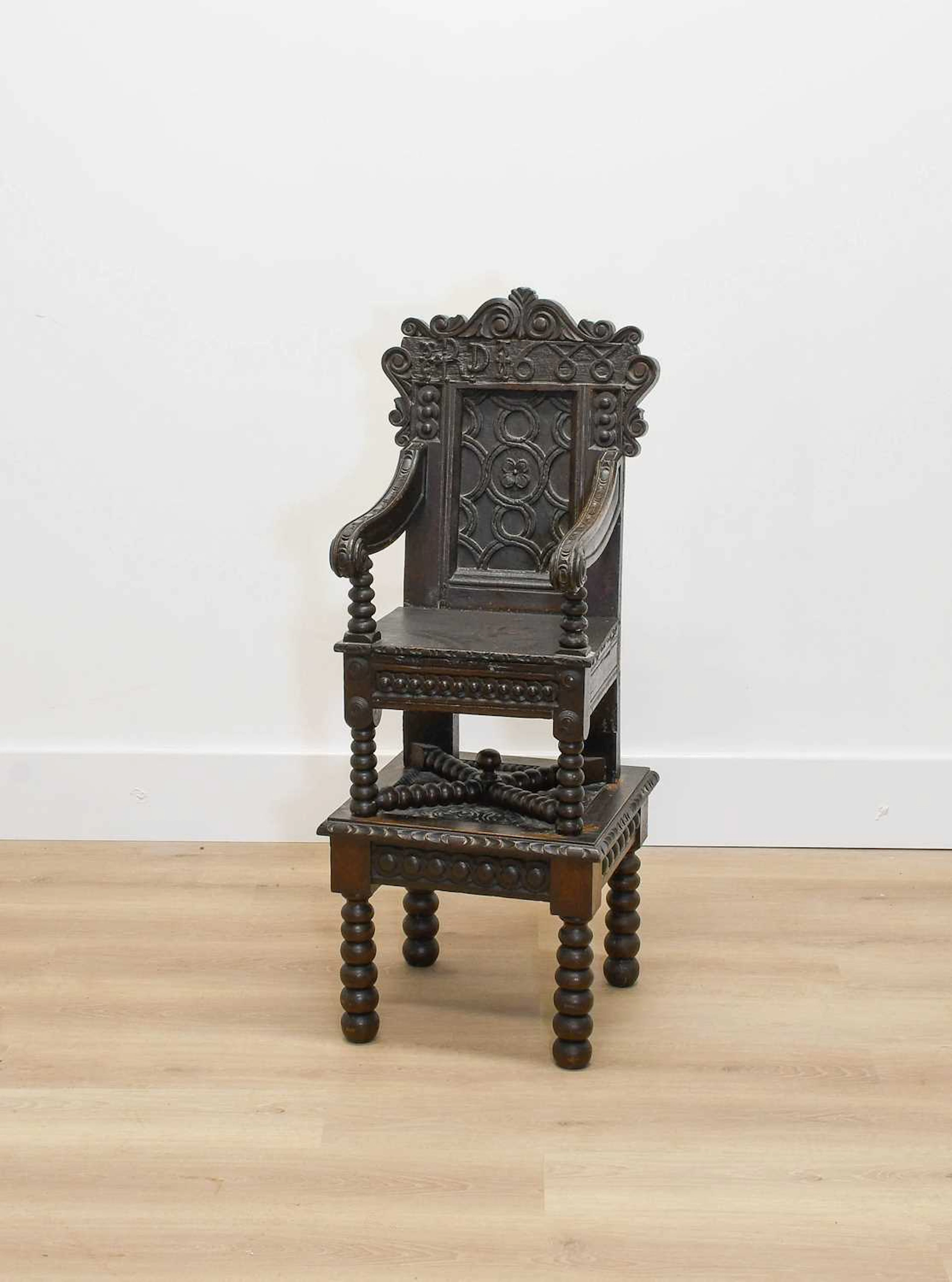 A Joined Oak Carved Child's Highchair on Stand, initialled R.D and dated 1688