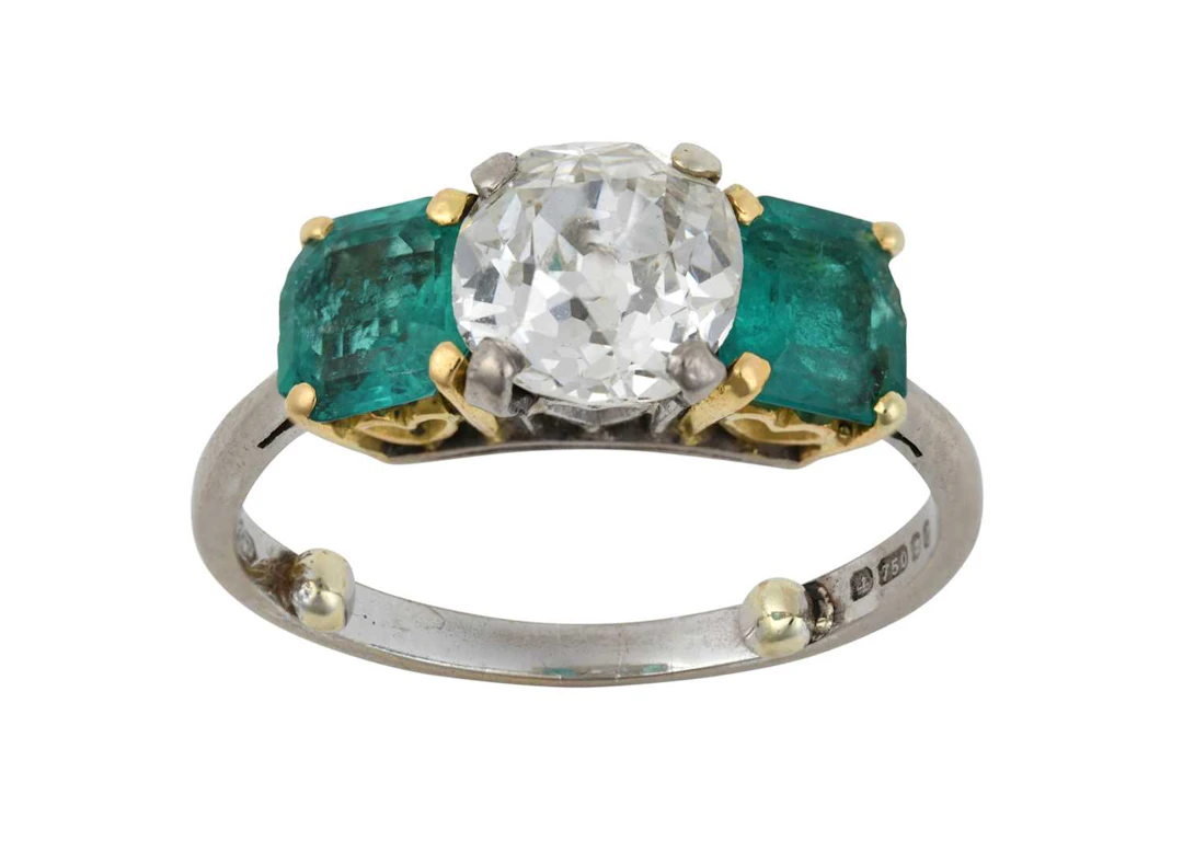 An 18 Carat Gold Diamond and Emerald Three Stone Ring