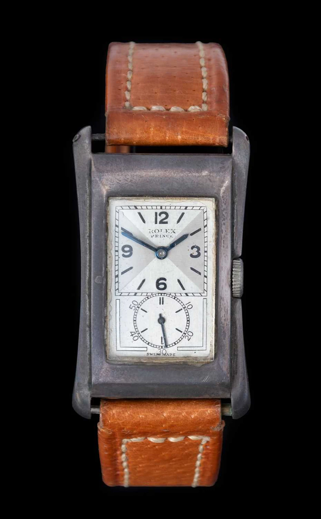 Rolex: An Art Deco Silver Flared Sided Rectangular Wristwatch, signed