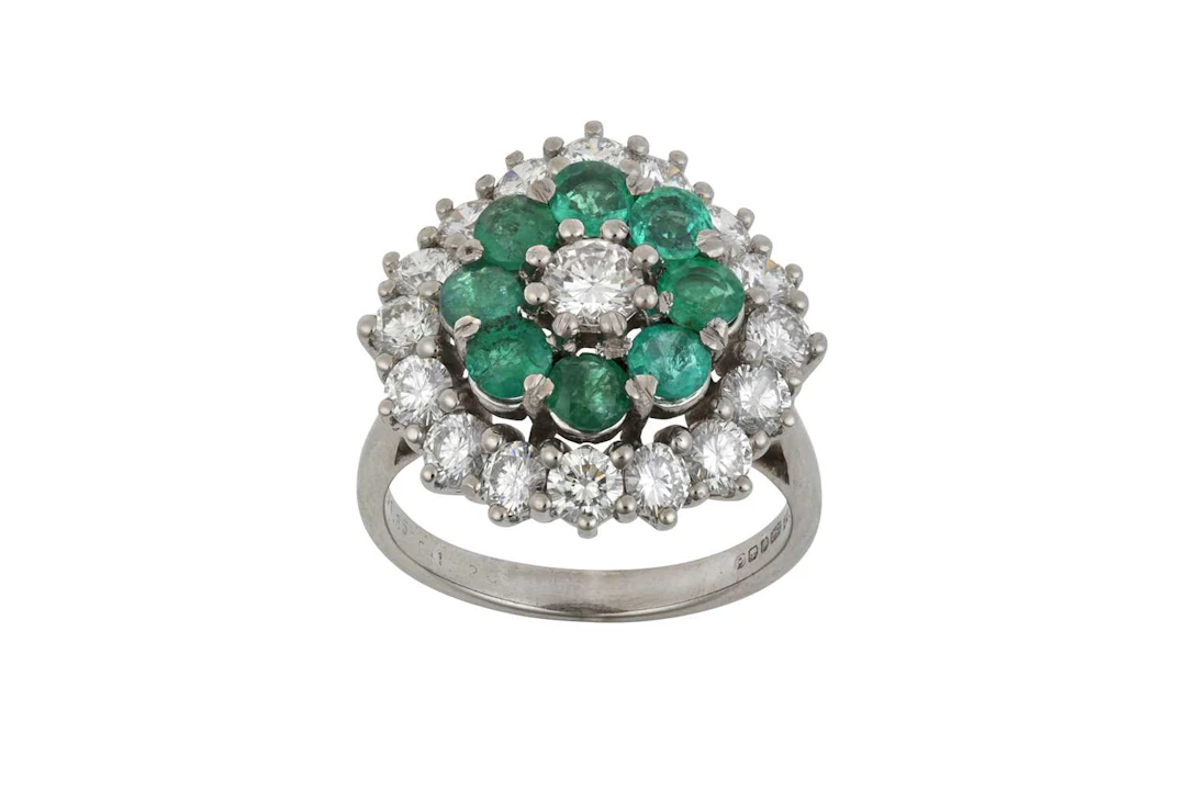 An 18 Carat White Gold Emerald and Diamond Cluster Ring