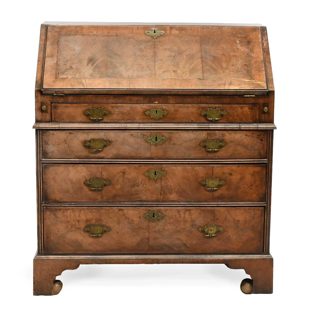A George I Walnut, Crossbanded and Featherbanded Bureau, early 18th century