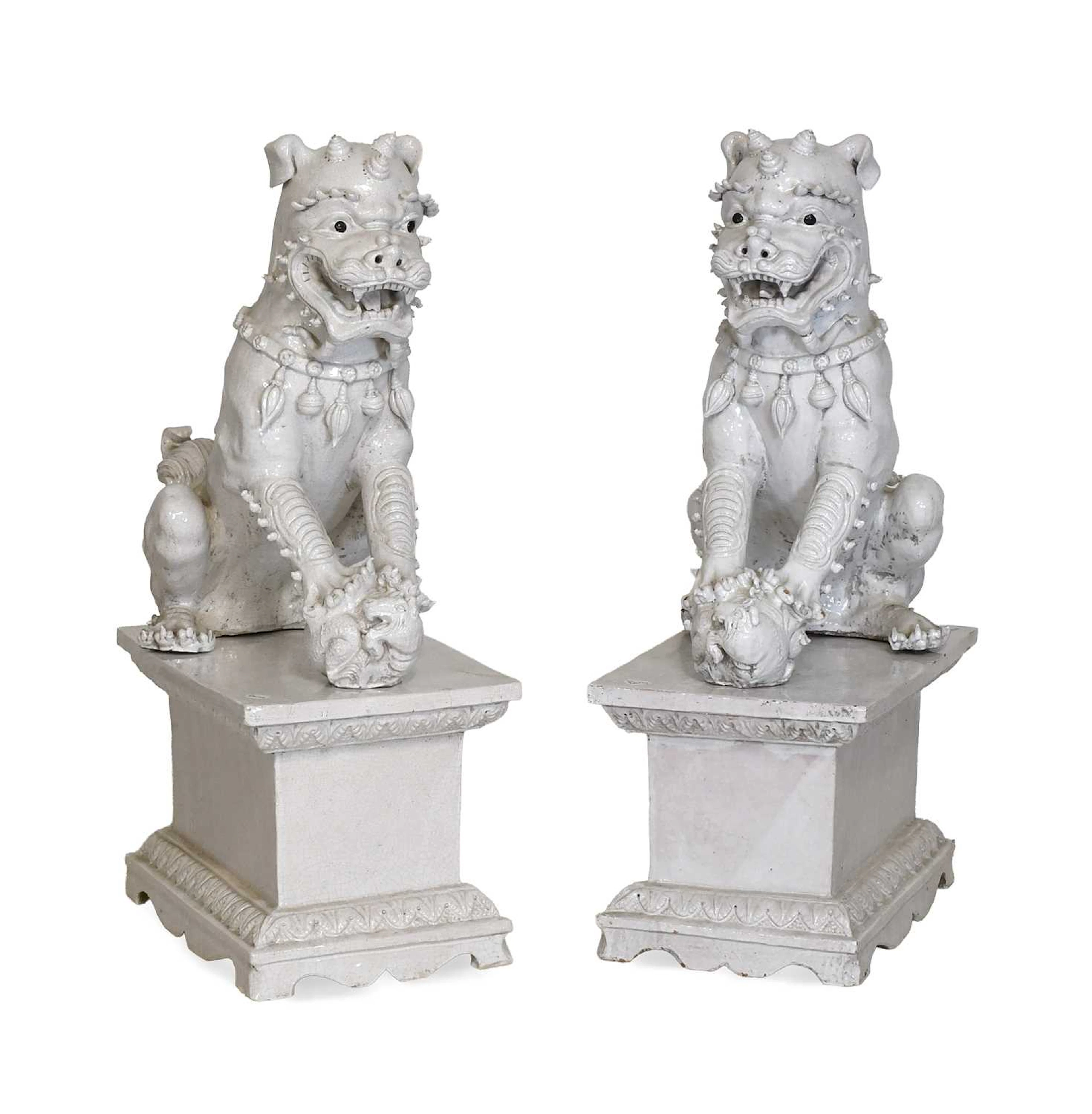 A Pair of Chinese Blanc de Chine Crackle Glaze Buddhistic Lions