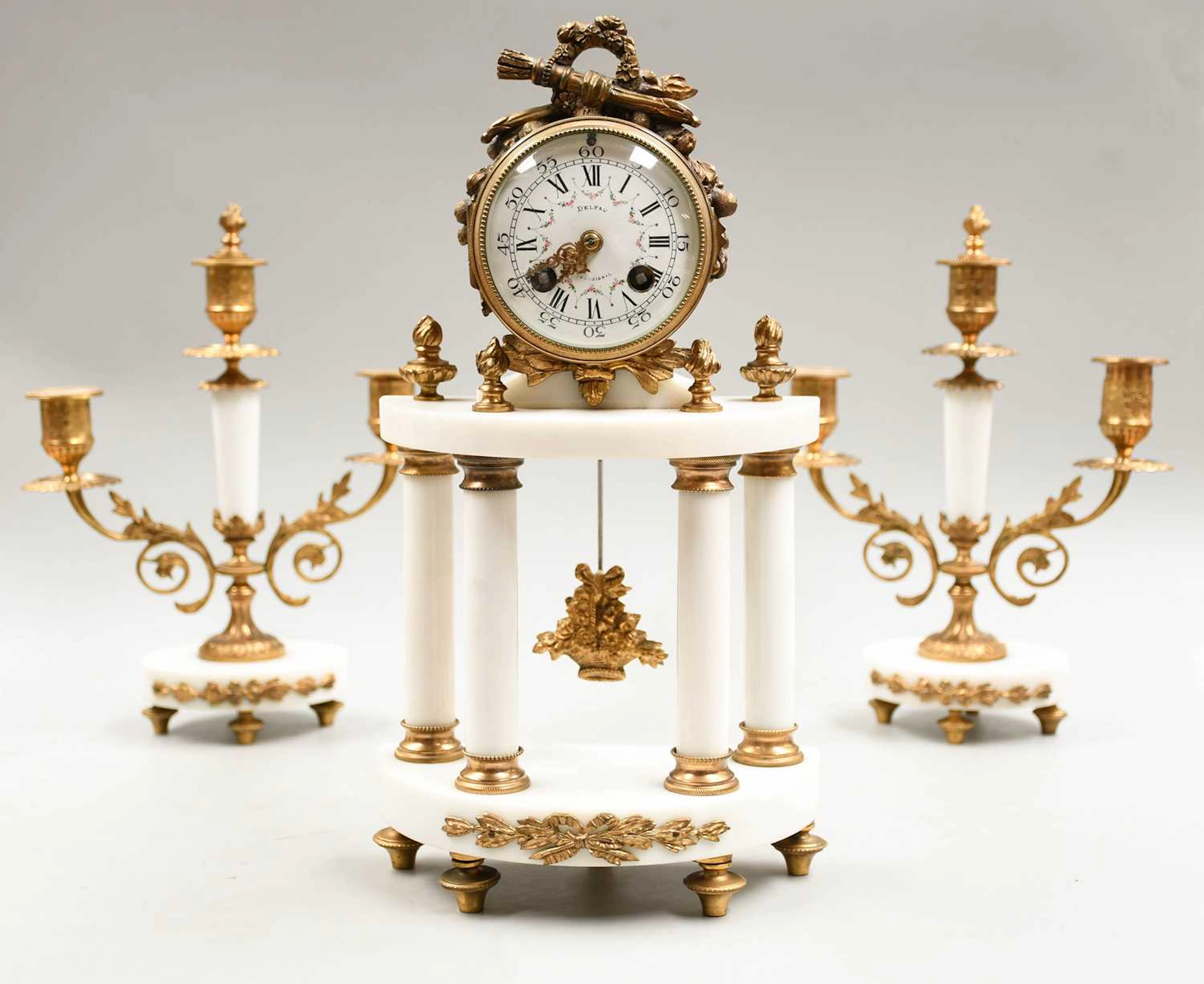 A French Portico Gilt-Metal and Marble Striking Mantel Clock Garniture