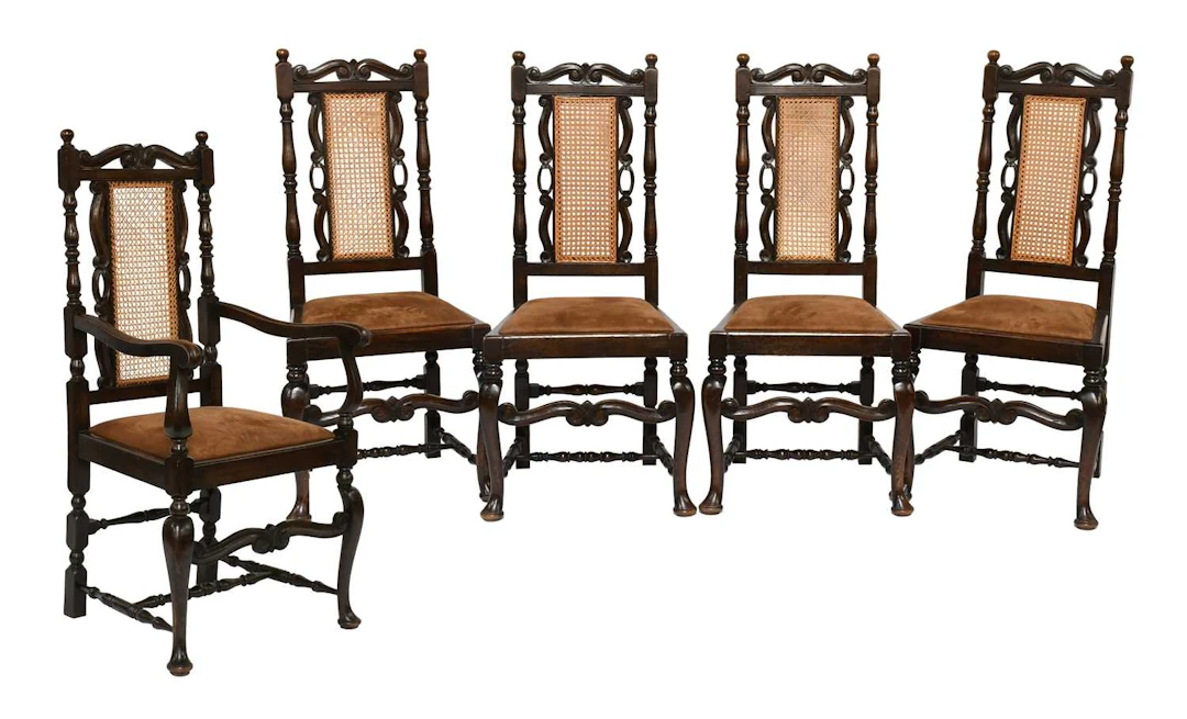 A Set of Five Carved Oak Cane Back Dining Chairs