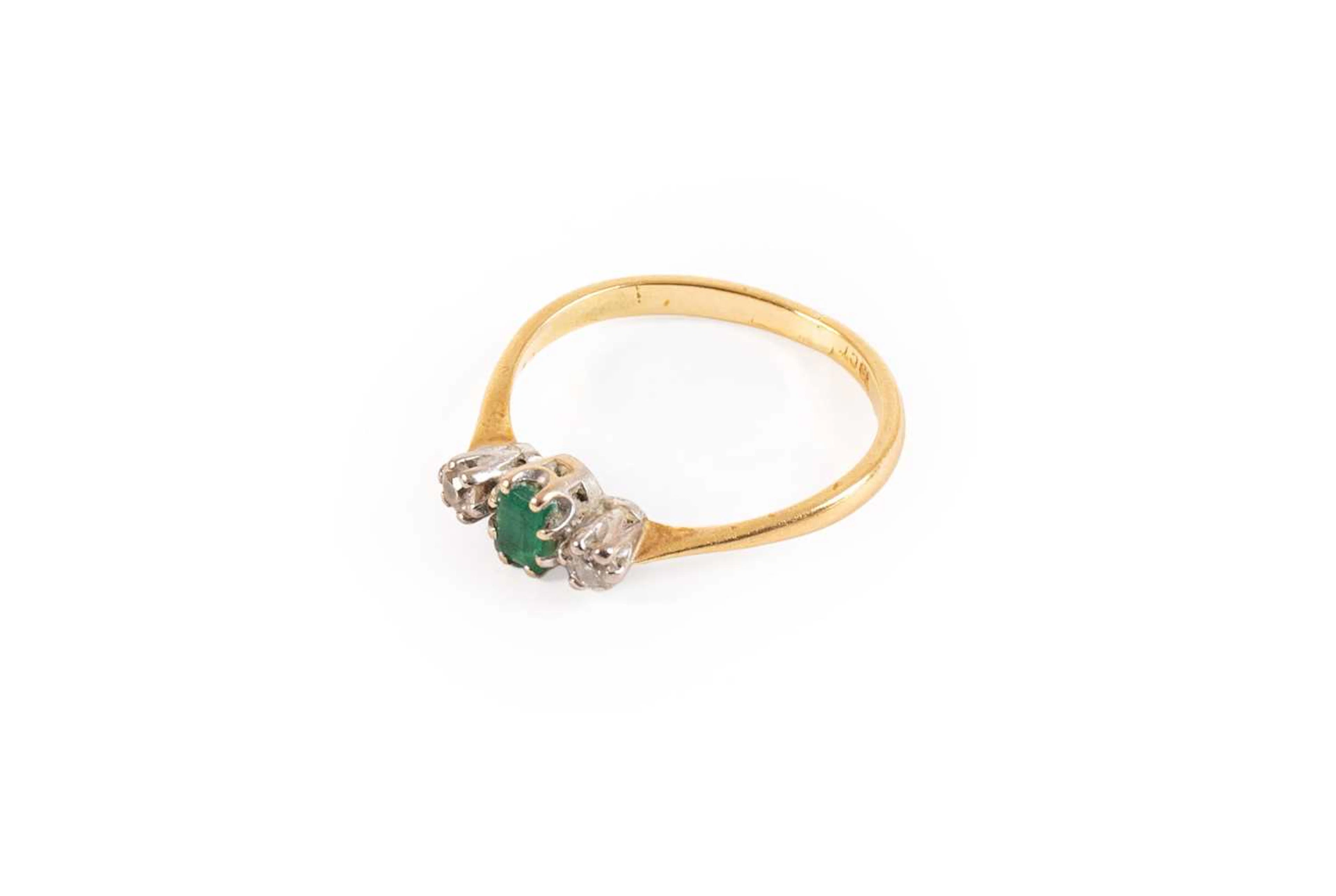 An Emerald and Diamond Three Stone Ring