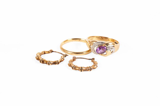 A 9 Carat Gold Band Ring, A 9 Carat Gold Amethyst Ring, A Pair of Hoop Earrings