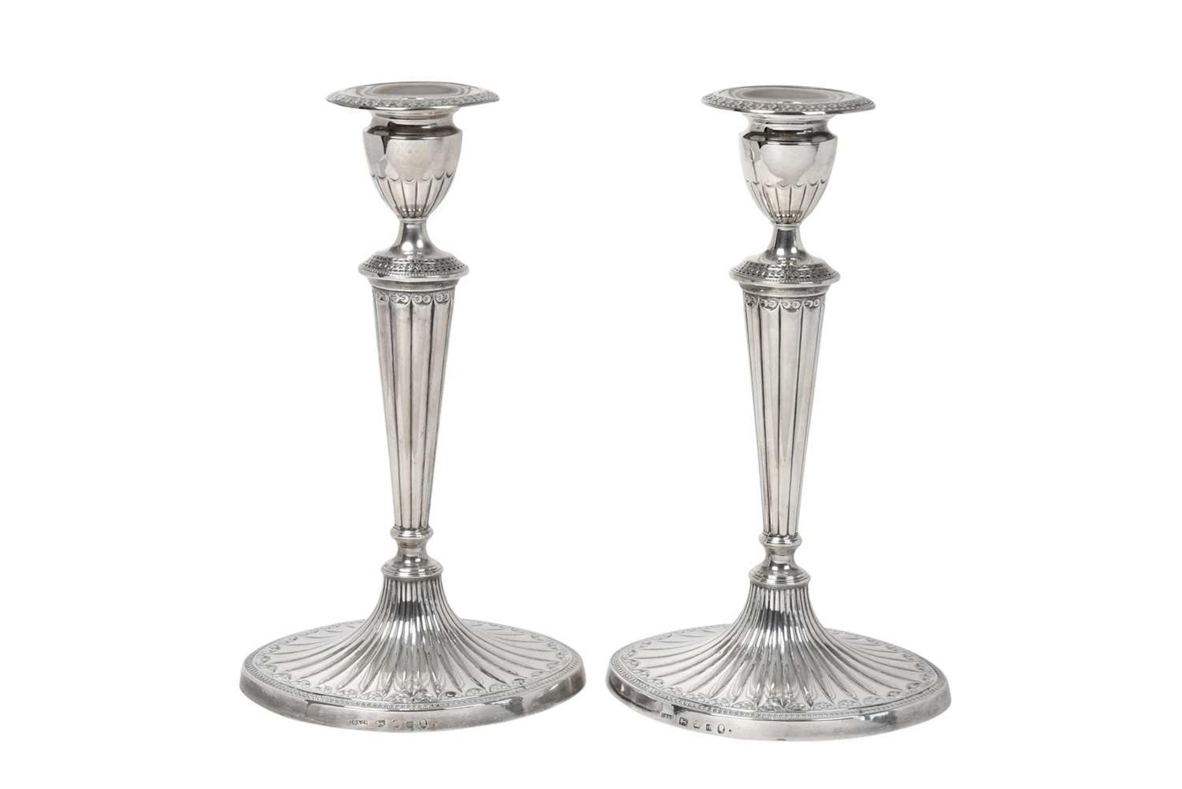 A Pair of George III Silver Candlesticks by John Green, Roberts, Mosley