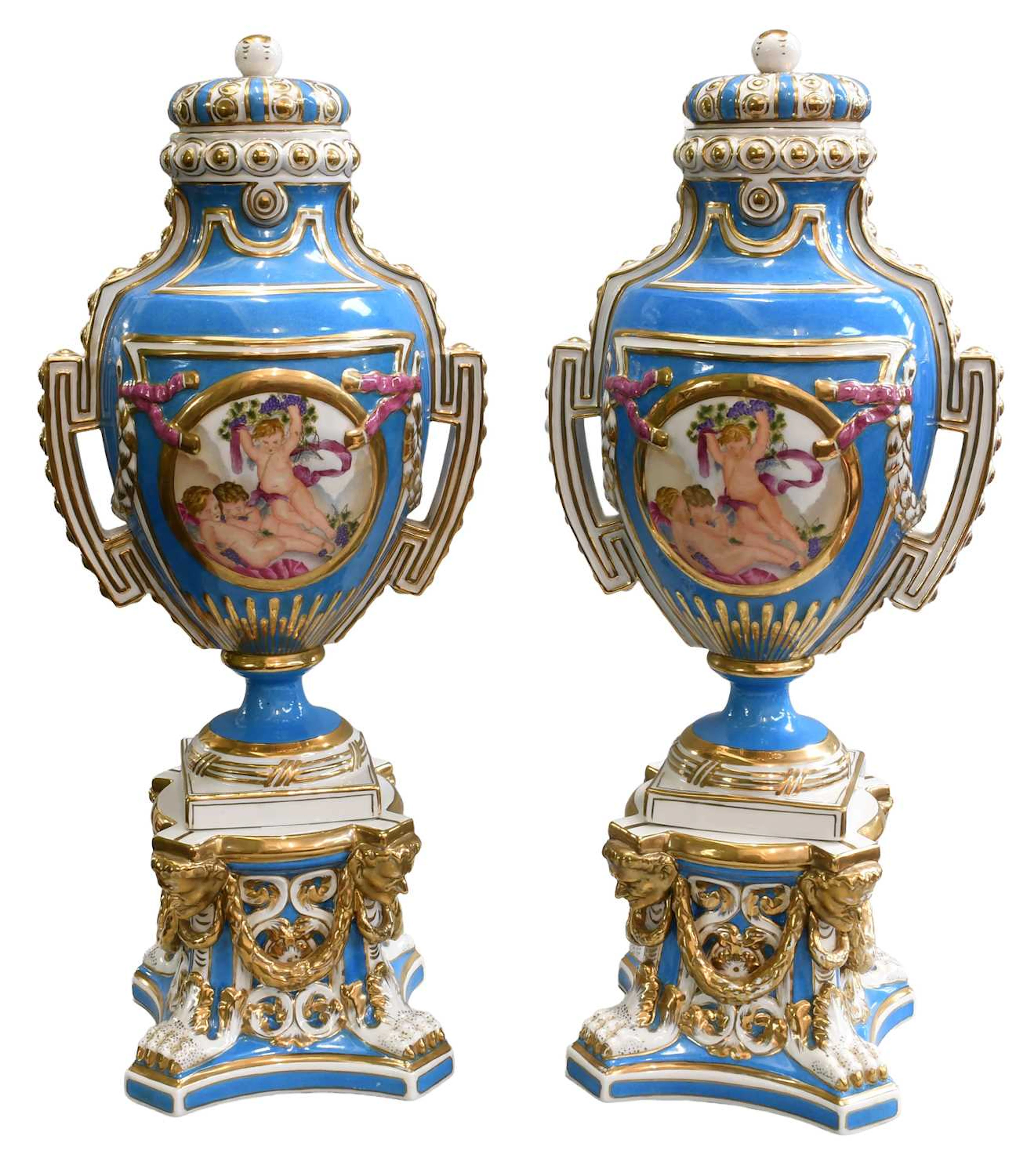 A Pair of Sèvres Style Porcelain Urns, Covers, and Stands, 20th century