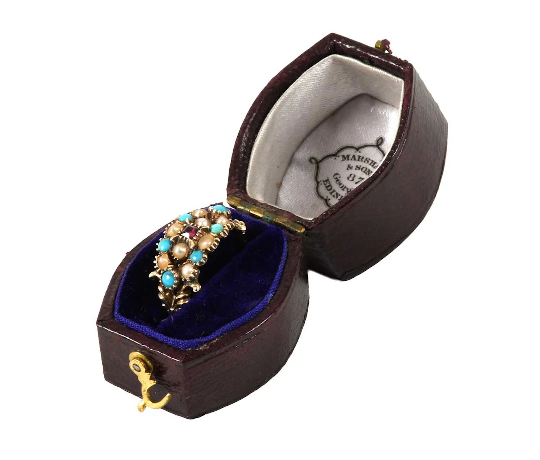 A Turquoise, Split Pearl and Garnet Ring
