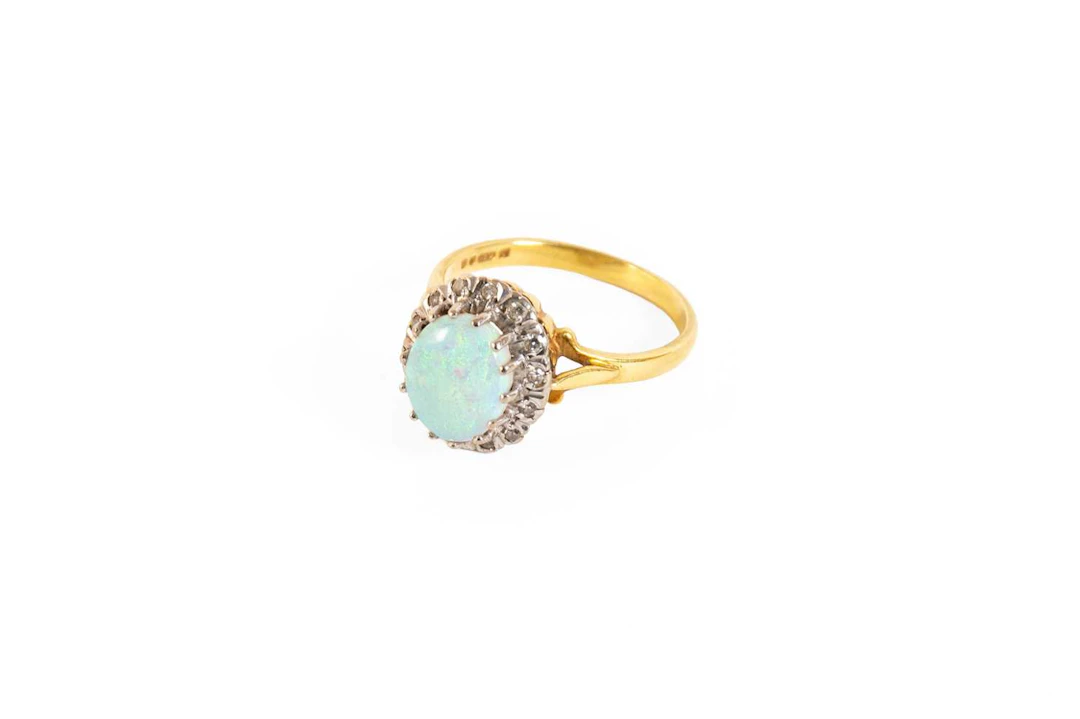An 18 Carat Gold Opal and Diamond Cluster Ring