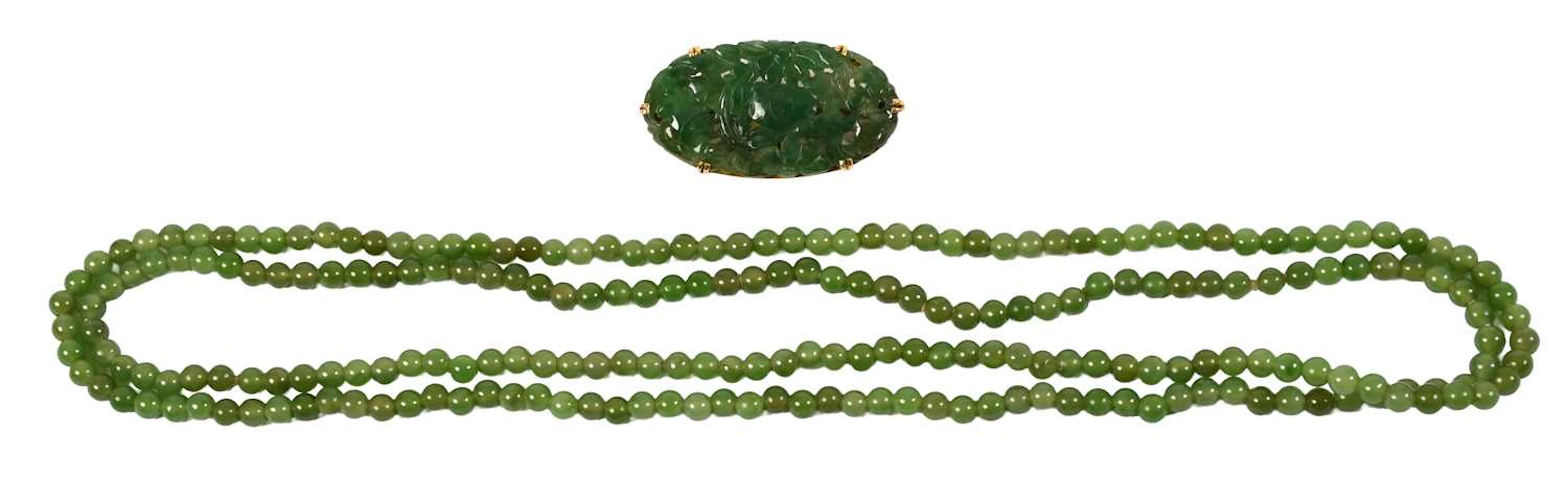 A Jade Brooch, A Nephrite Bar Brooch, A Strand of Nephrite Beads