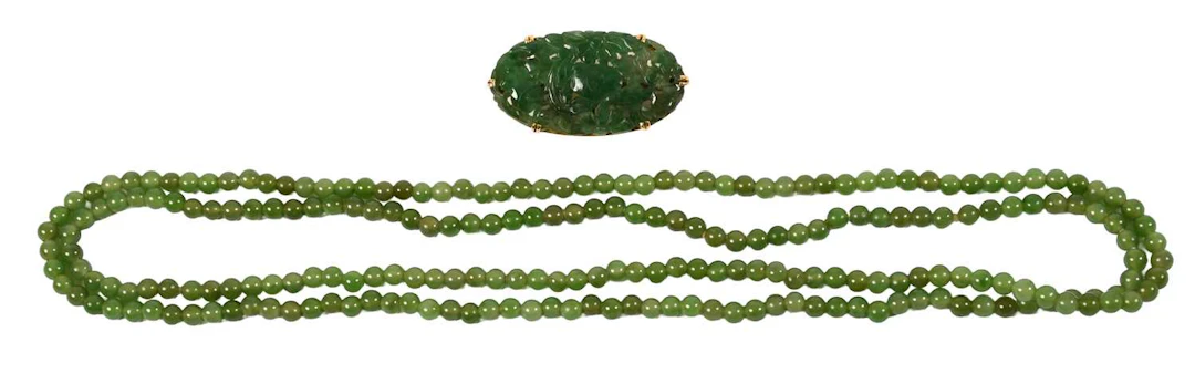 A Jade Brooch, A Nephrite Bar Brooch, A Strand of Nephrite Beads
