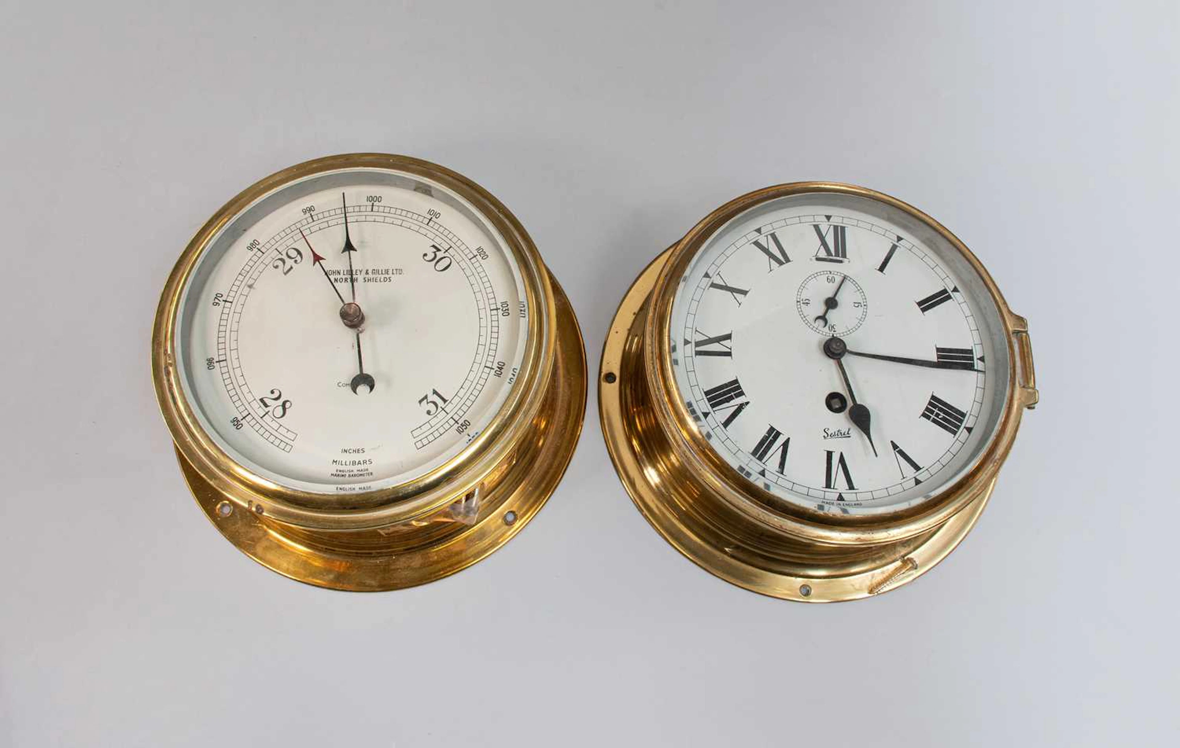 A ships bulk head timepieces and a barometer (2)...