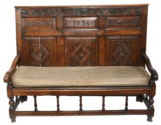A Joined Oak and Carved High-Back Settle, initialled JGM and dated 1725